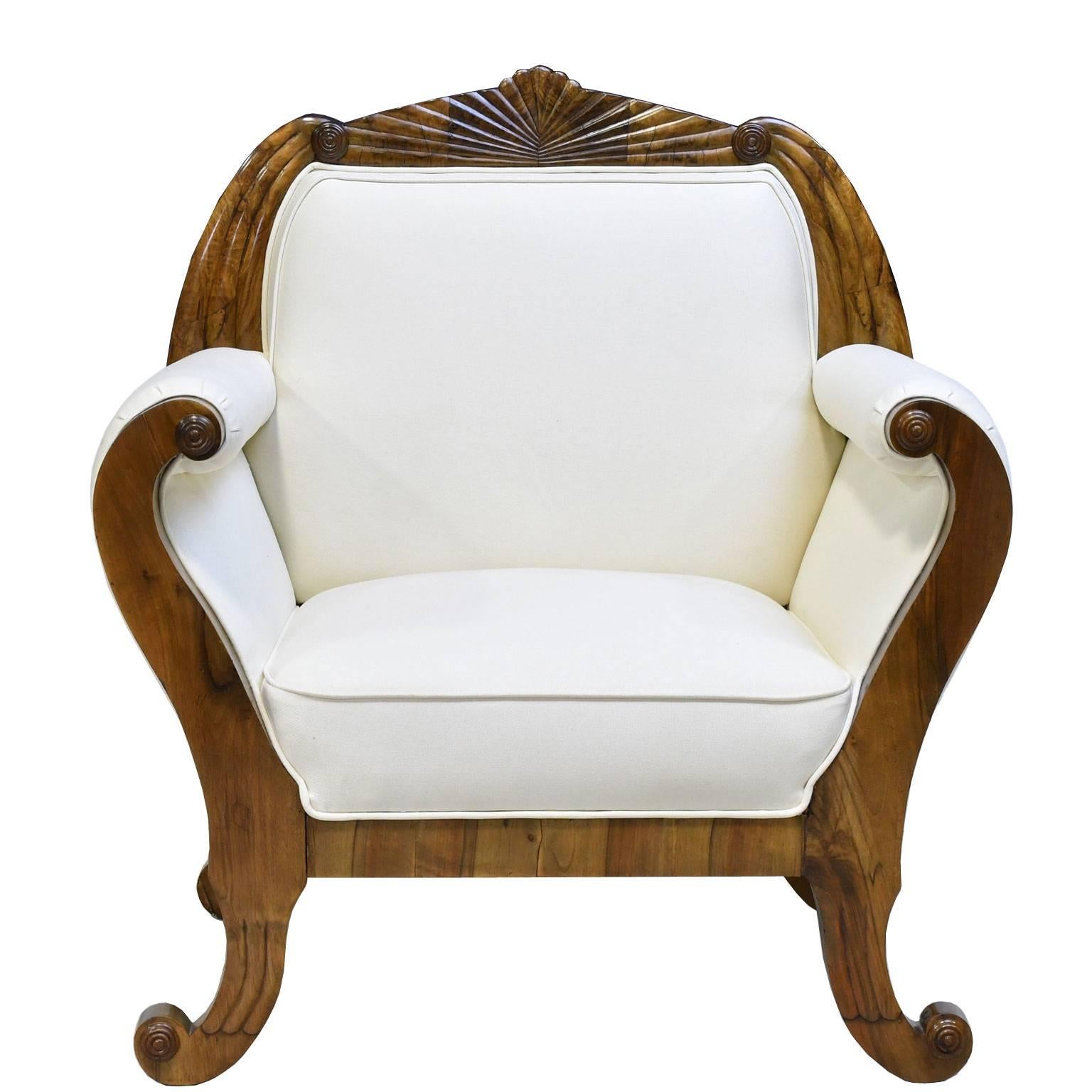 A very beautiful pair of South German Biedermeier armchairs or bergères in fine walnut each with shaped, fan-carved crest rail above scrolled armrests terminating in out-scrolled feet, Germany, circa 1830.
These armchairs are being sold as a set not