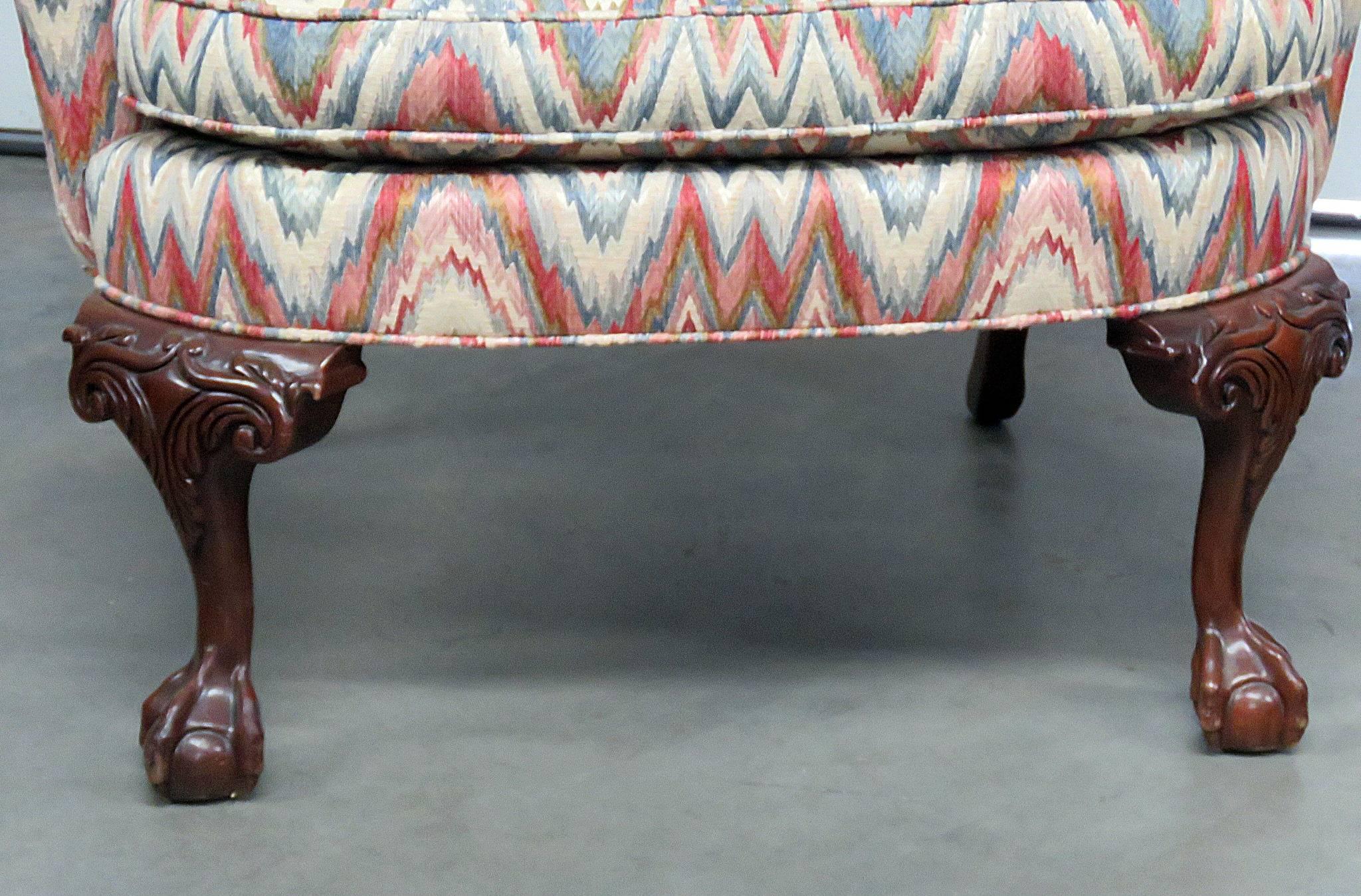 Pair of southwood Chippendale style mahogany wing chairs with ball and claw feet. Measures: 20