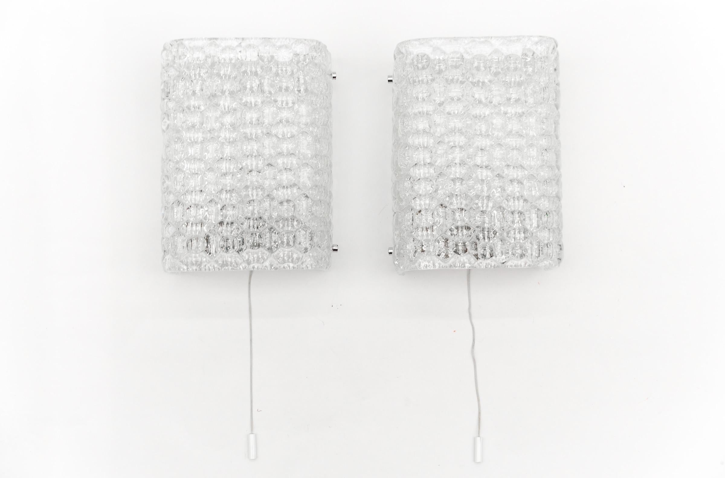 Pair of Space Age Bubble Glass Wall Lights, 1970s

The lamps are executed with each 1x E27 Edison screw fit bulbs. It is in working condition. It runs both on 110 / 230 volt.

The usual slight signs of wear and a beautiful patina.

It is wired and