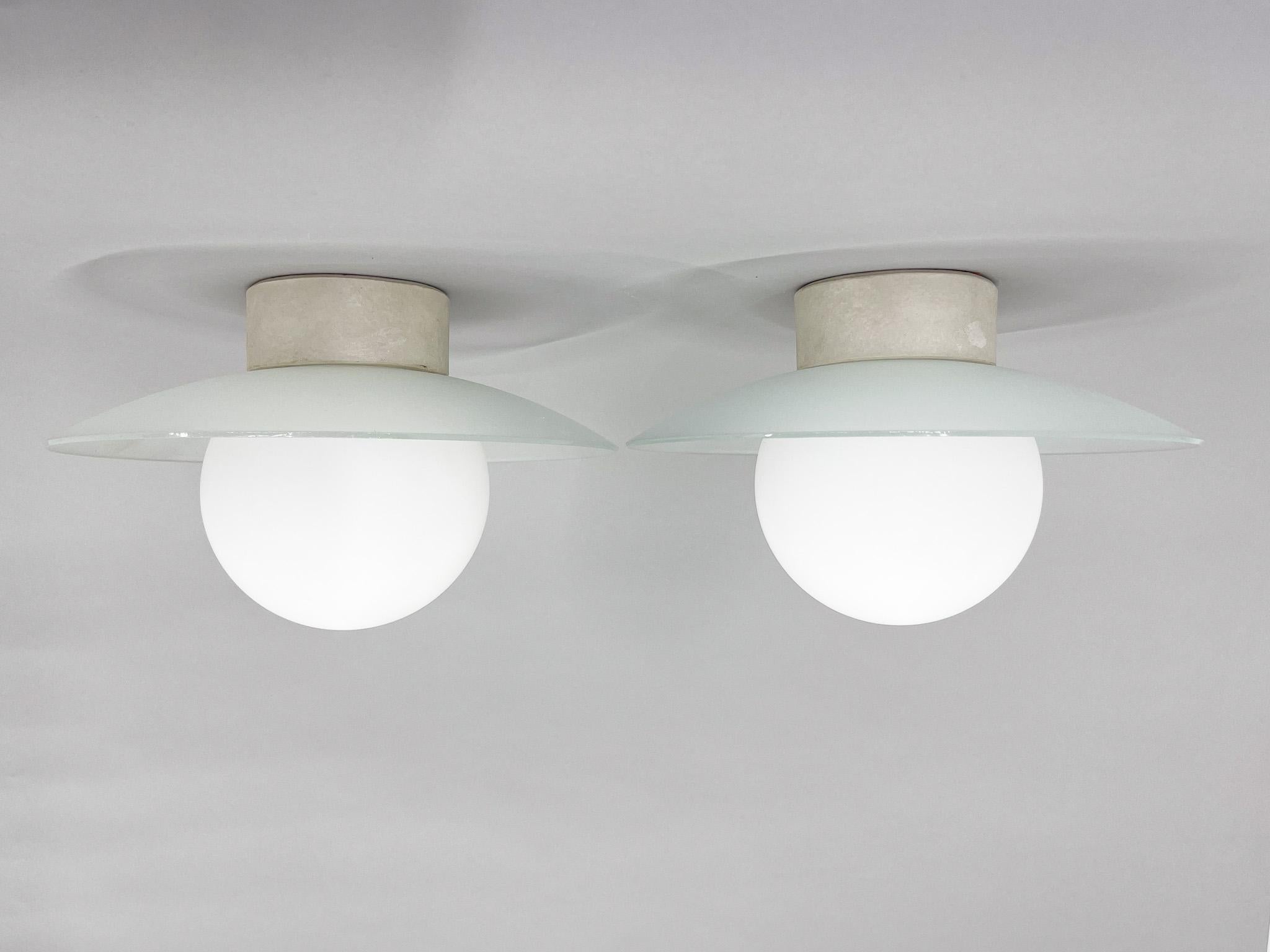 Seto of two vintage flush mounts or ceiling lights with ceramic base, milk glass ball and circle made of frosted glass. Unique piece of lighting. Rewired: 2x1 E25-E27 bulbs. US wiring compatible.
