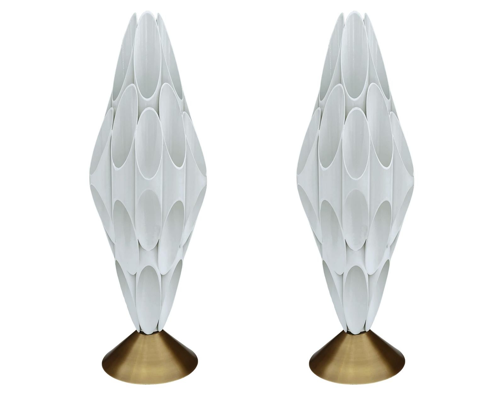 A pair of striking & chic tubular table lamps made by Designline. These feature heavy brass construction. Takes one standard bulb. Cord is very long with built in switch.