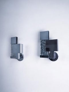 Pair of Space-age sconces, chromed metal and cut glass, Italy, 1980