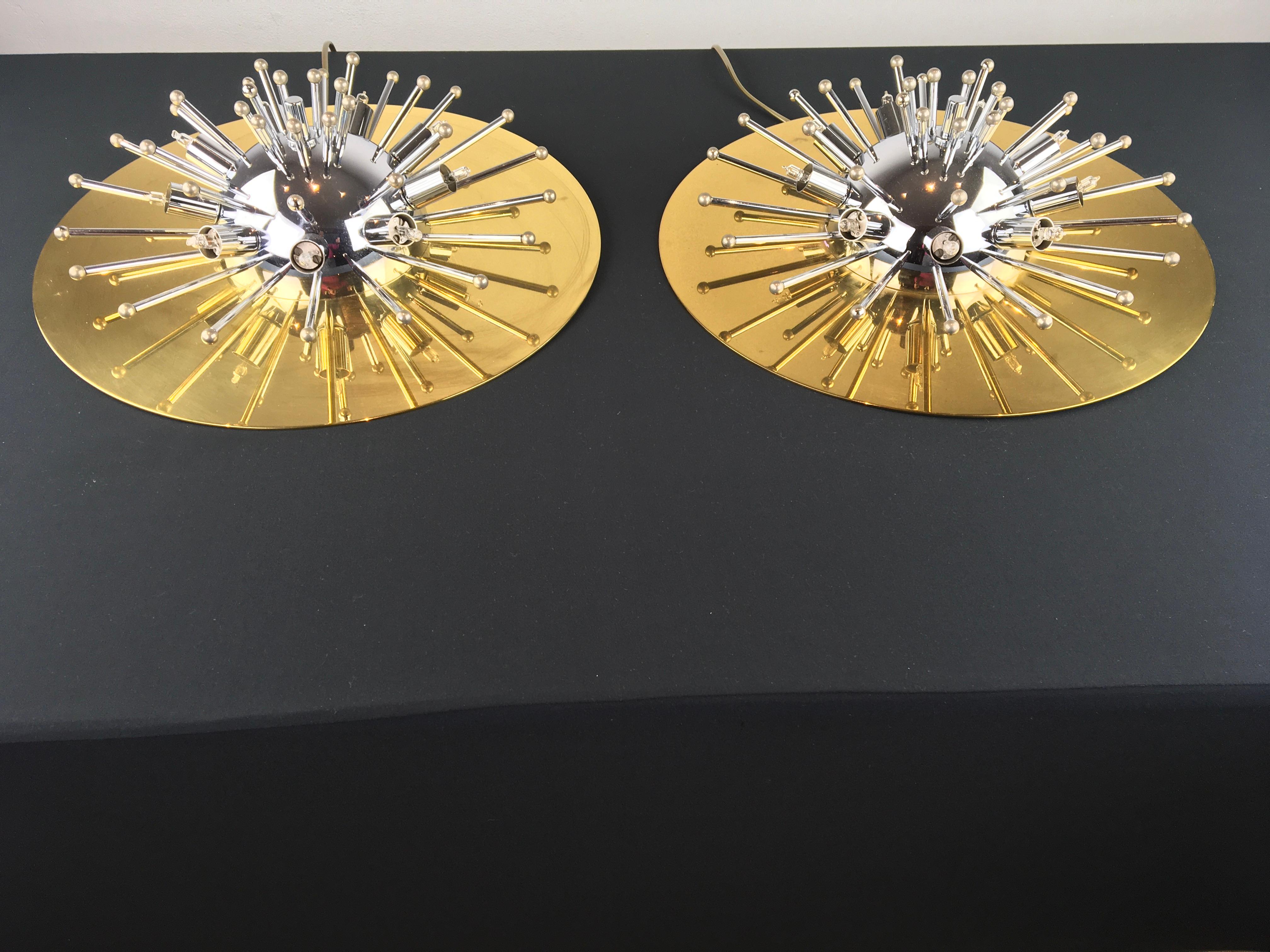 Pair of Sputnik wall lights or flushmounts.
These Space Age lighting have a heavy brass round base with chromed sputnik details all over. These half sputnik scones look great! 
They have each 9 insert light points, 18 big, 9 medium and 9 small