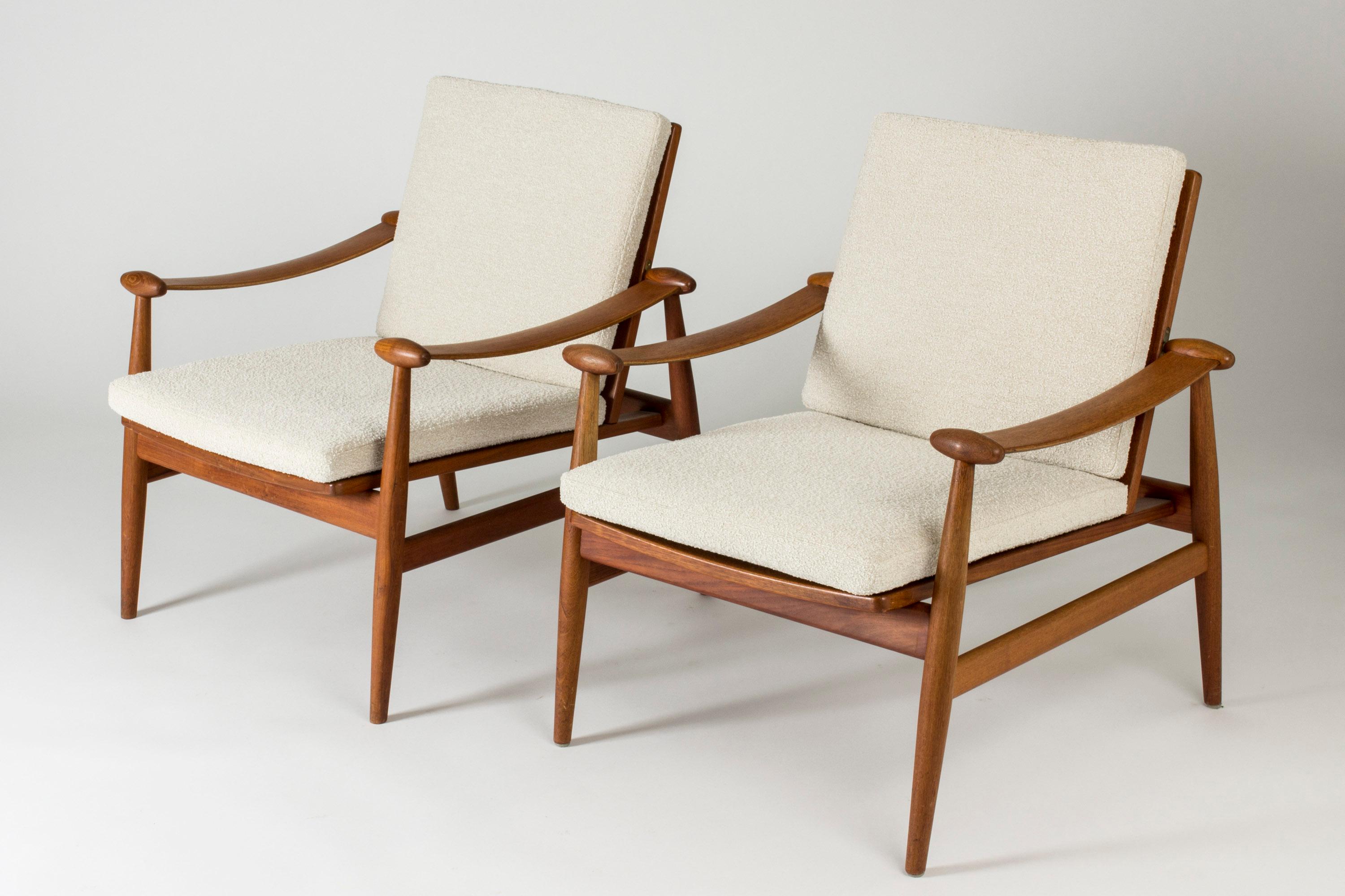 Pair of beautiful “Spade” lounge chairs by Finn Juhl, model FD 133. Designed in 1954. Made of teak with flowing lines, cushions upholstered with bouclé fabric.