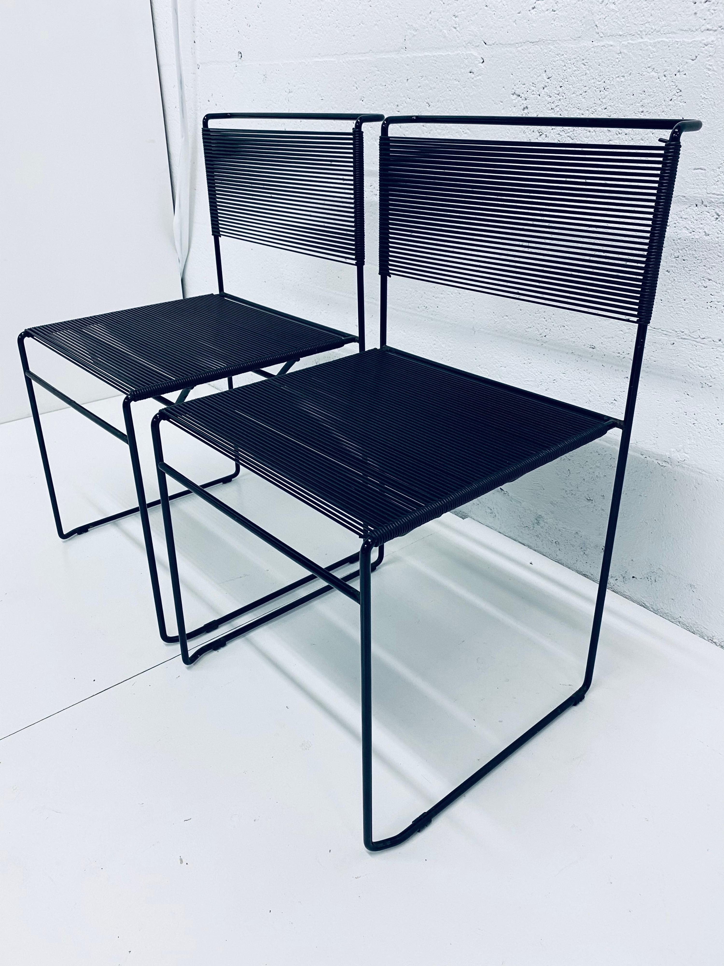 Designed by Giandomenico Belotti (1922-2004), this pair of Black Spaghetti chairs is quite comfortable with their PVC spaghetti straps on steel bases. A most successful design by Belotti, they are a part of the MoMA collection. This edition