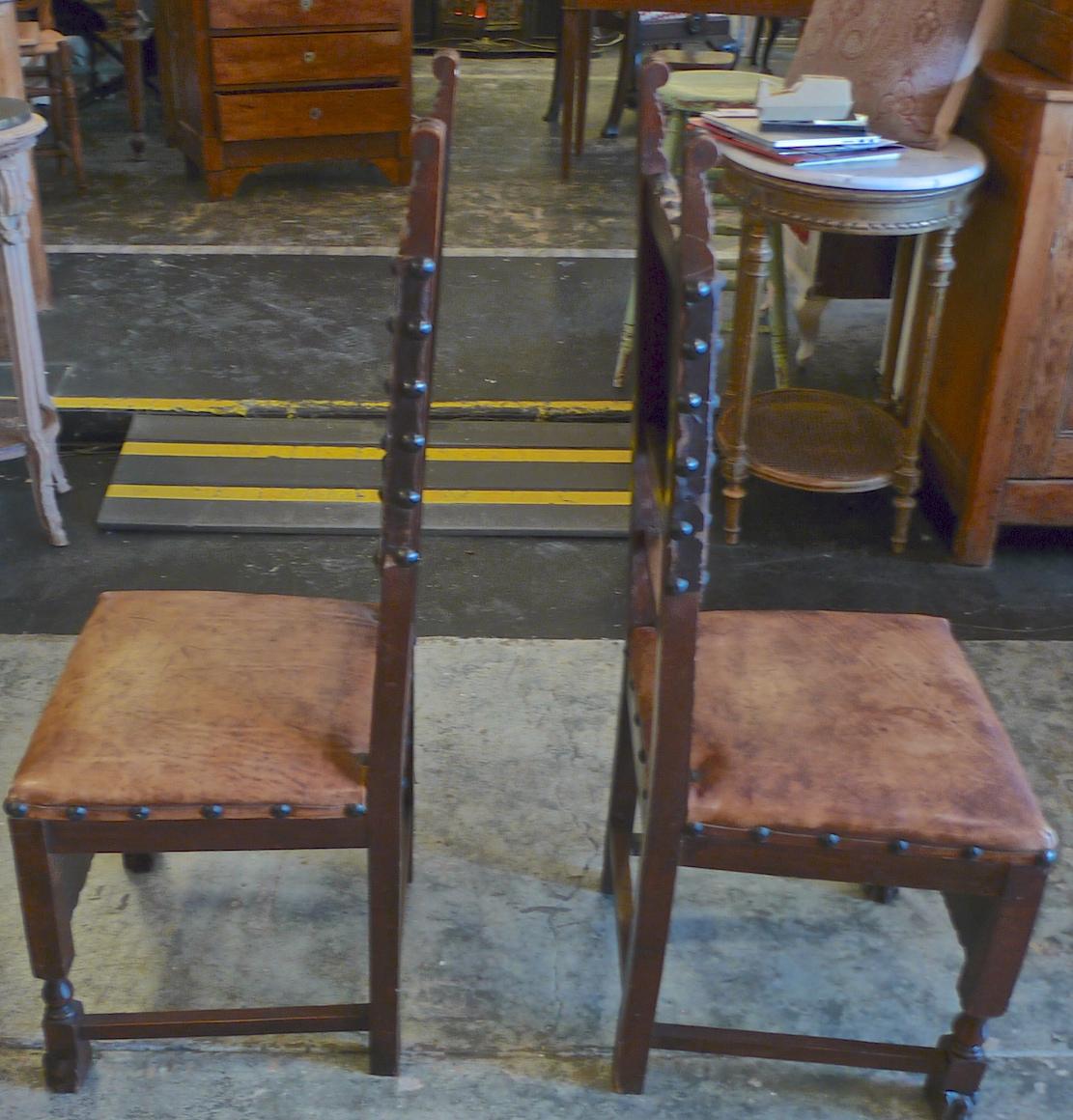Pair of Spanish 18th century high back studded leather dining chairs.
 