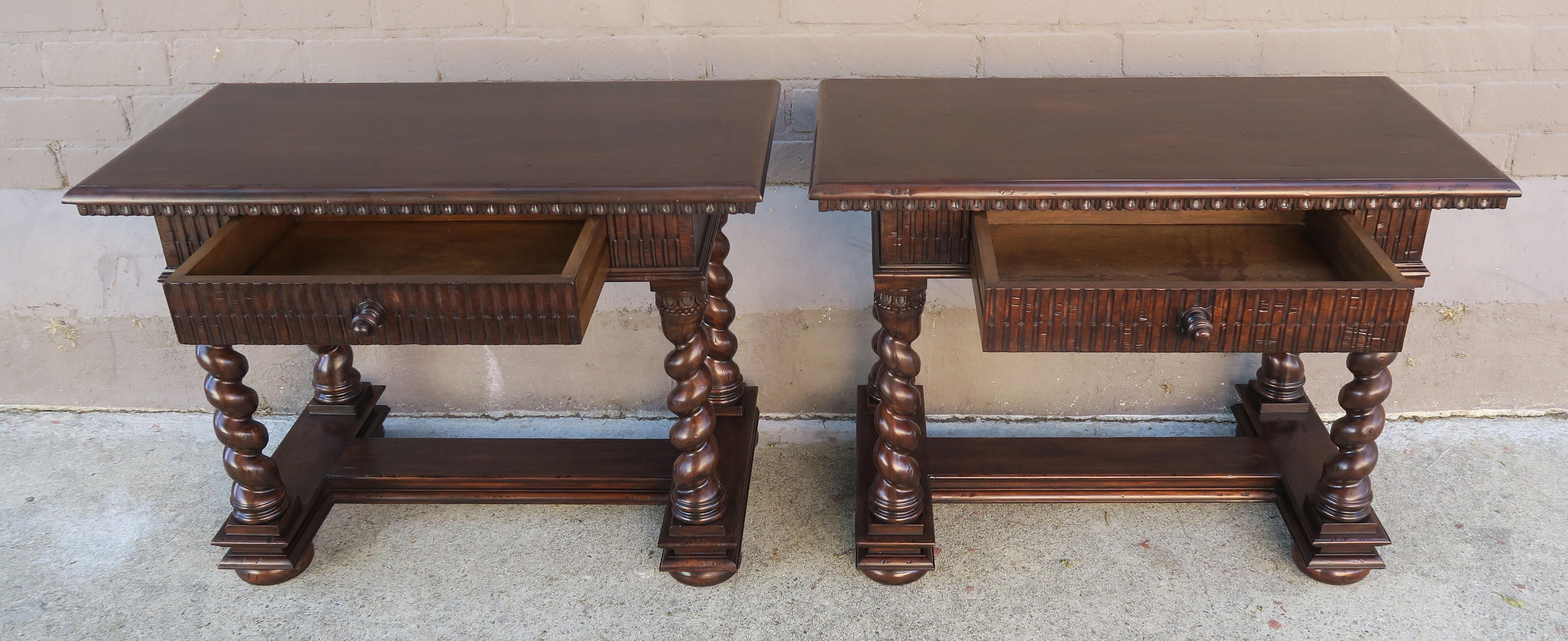 Pair of walnut finished Baroque style bedside tables with single drawer each. The intricately carved tables stand on four barley twisted legs that are connected by a center stretcher.