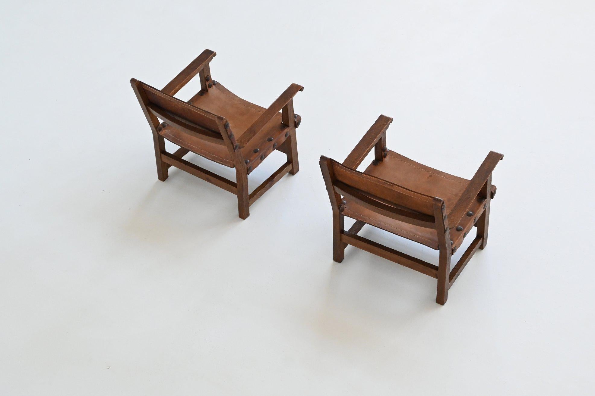 Leather Pair of Spanish brutalist lounge chairs oak and saddle leather Spain 1960