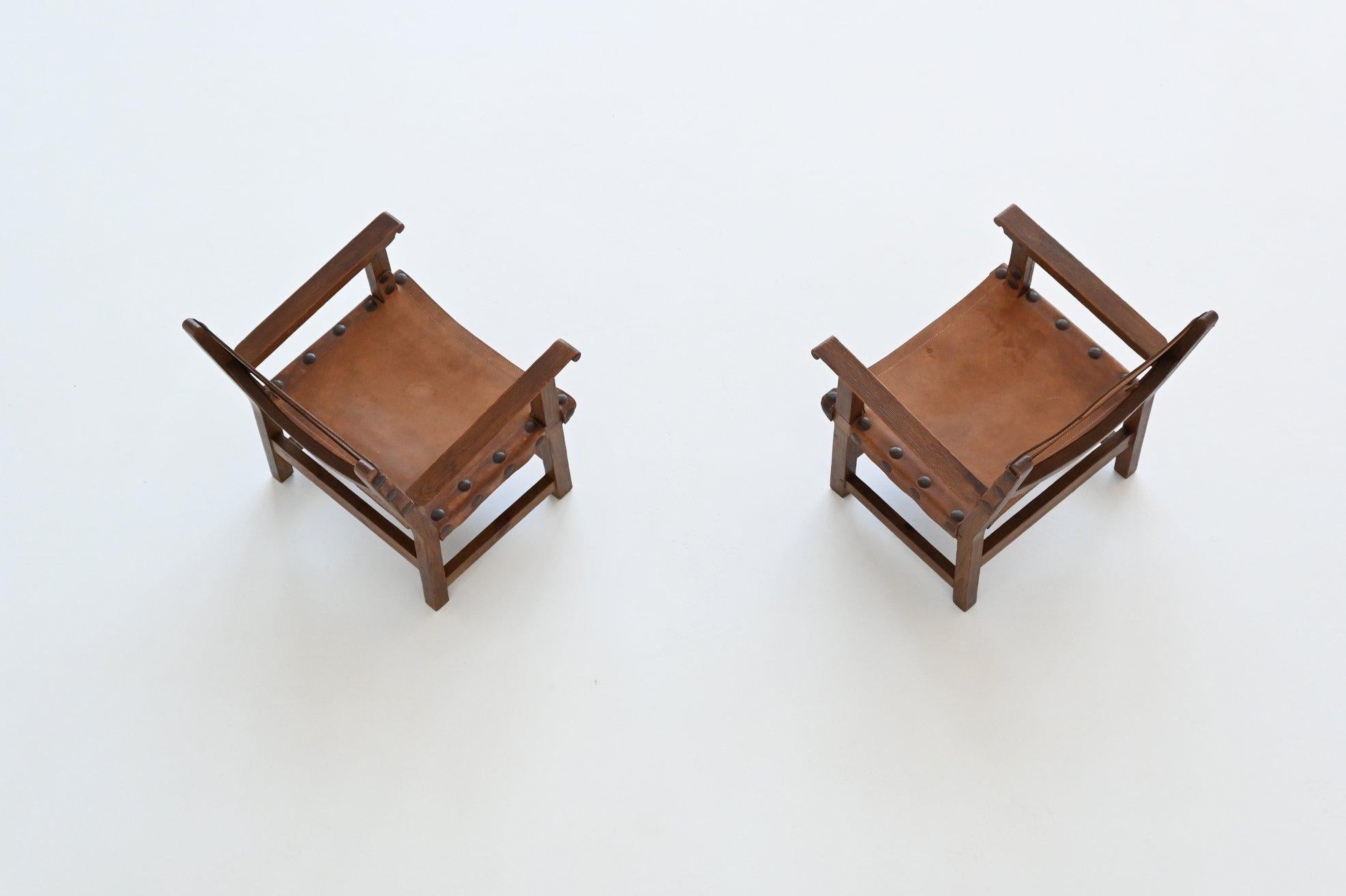 Pair of Spanish brutalist lounge chairs oak and saddle leather Spain 1960 1