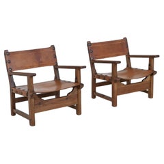 Pair of Spanish brutalist lounge chairs oak and saddle leather Spain 1960
