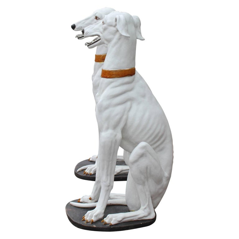 white ceramic greyhound statue