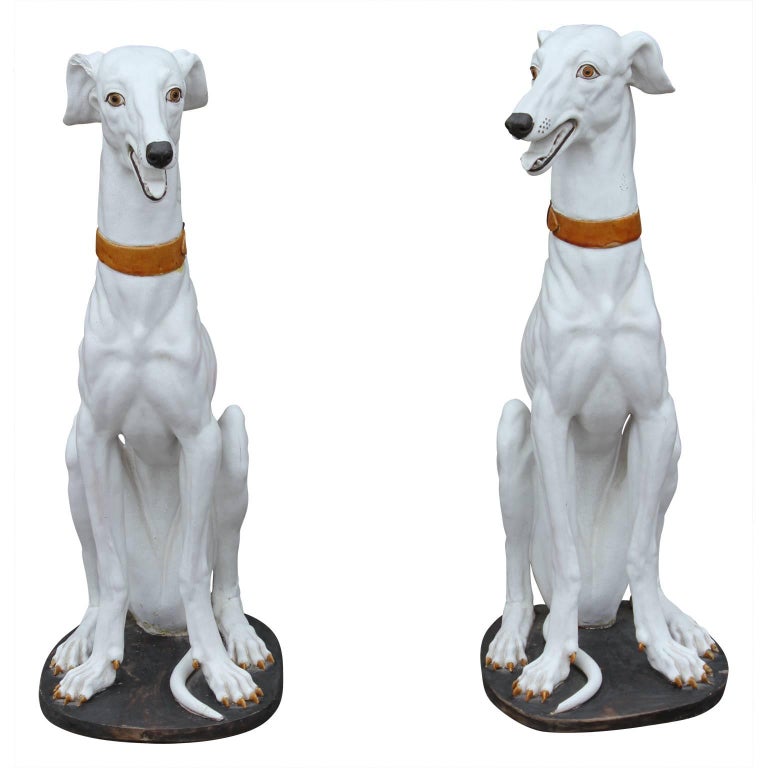 white ceramic greyhound statue