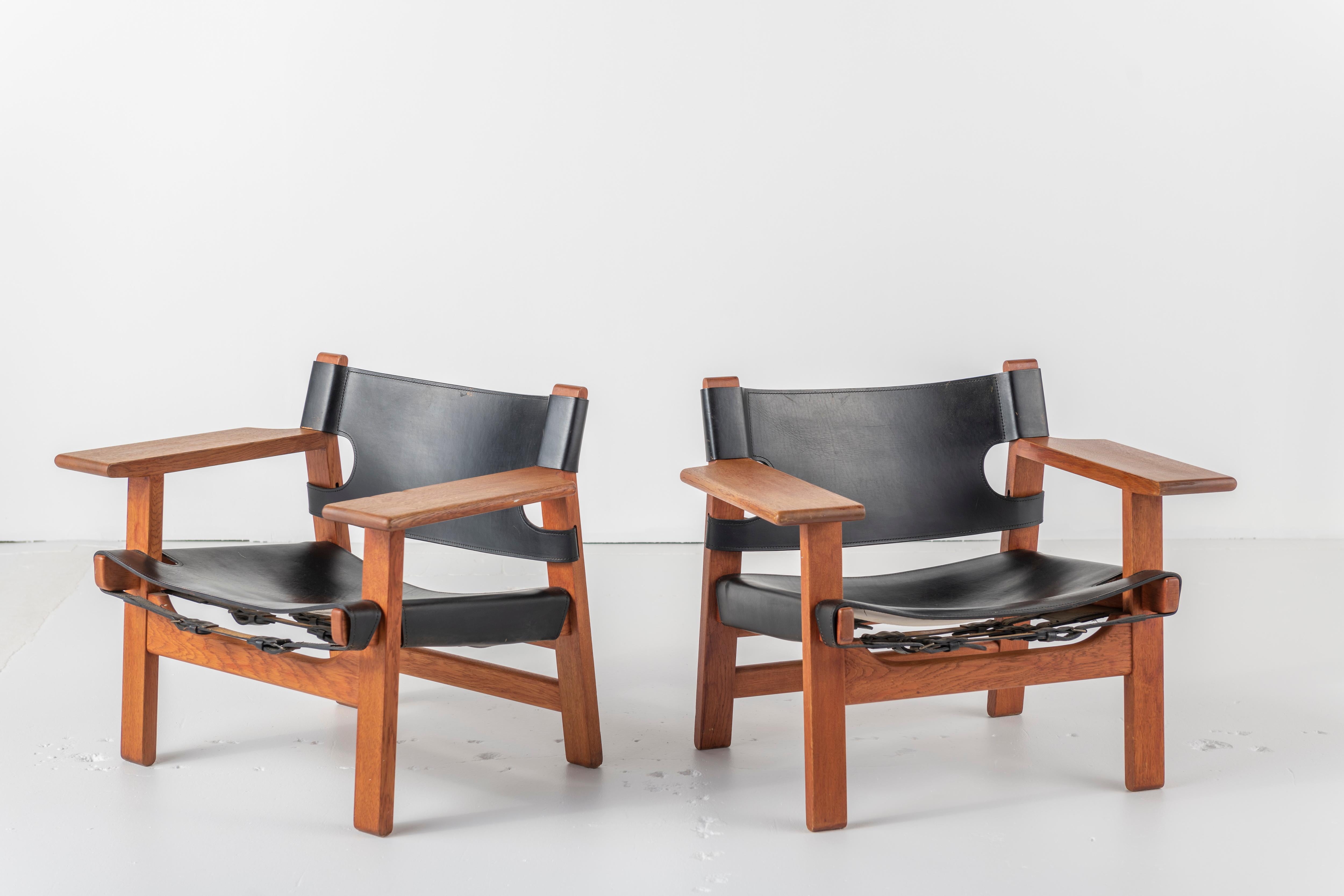 A pair of 'The Spanish Chair'. Designed by Børge Mogensen in 1958 for Fredericia Furniture. Made at Fredericia Furniture, mid 1960s. Made of solid oak with black saddle leather. Original untouched condition with natural patina.