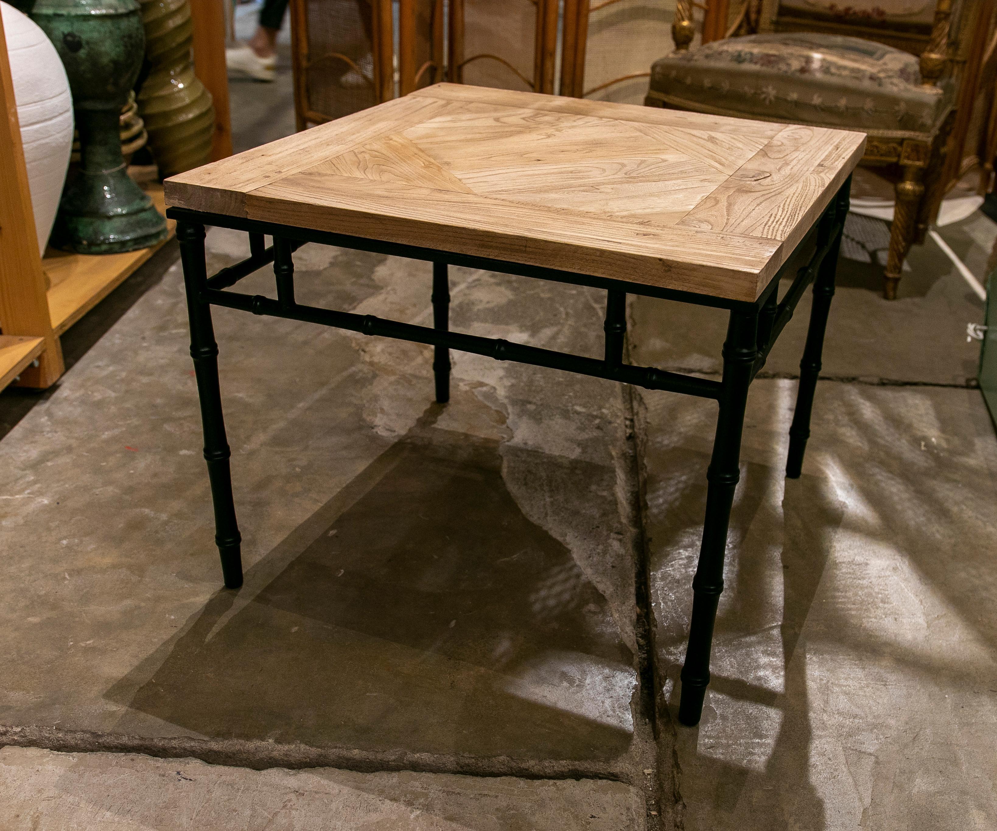 Pair of Spanish coffee table with iron base imitating bamboo and antique elm.
 
