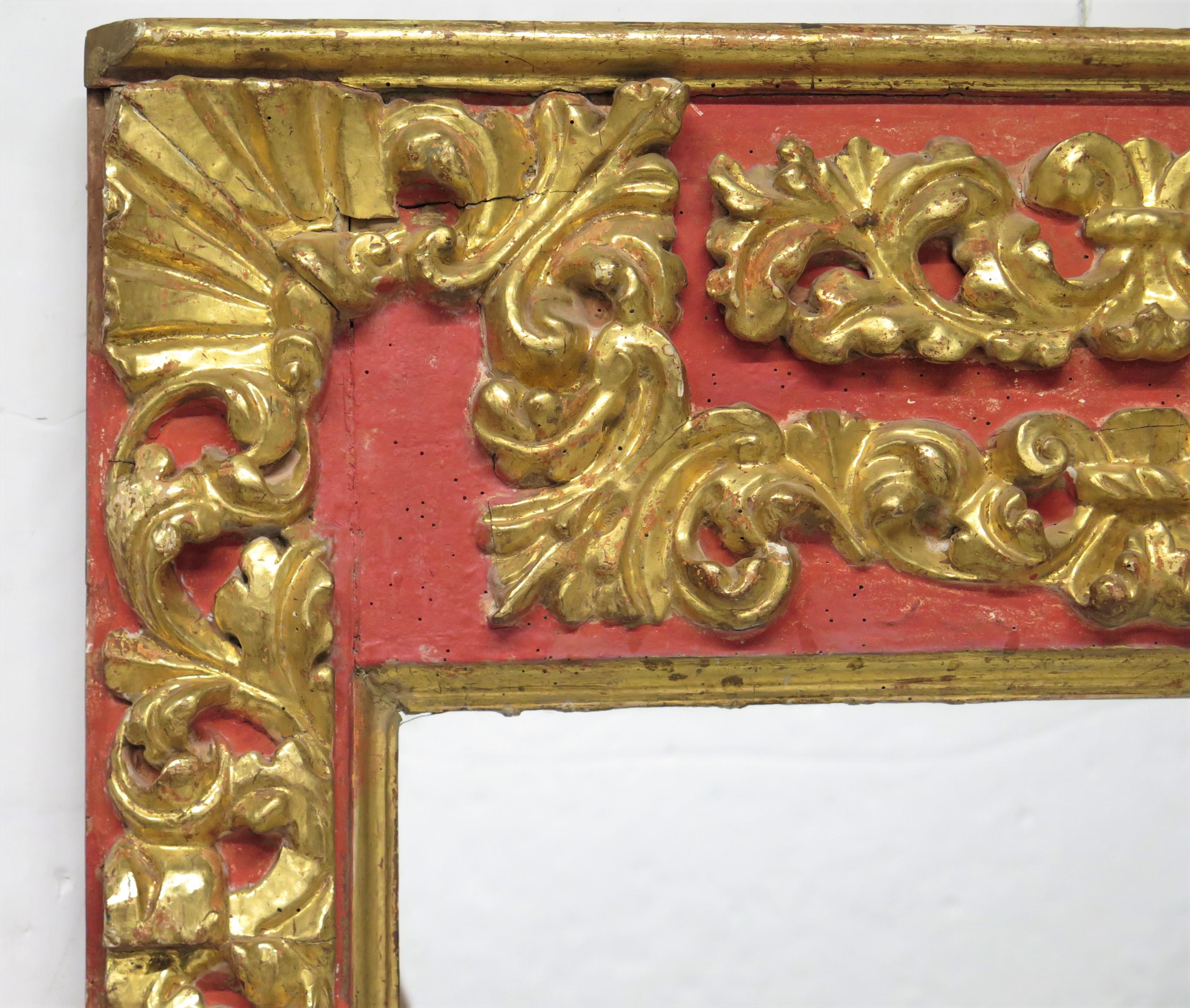 a pair of large hand-carved and gilded Spanish Colonial / Baroque mirrors each with flat mirror plate, putti heads each side, red   

MEASUREMENTS:

62
