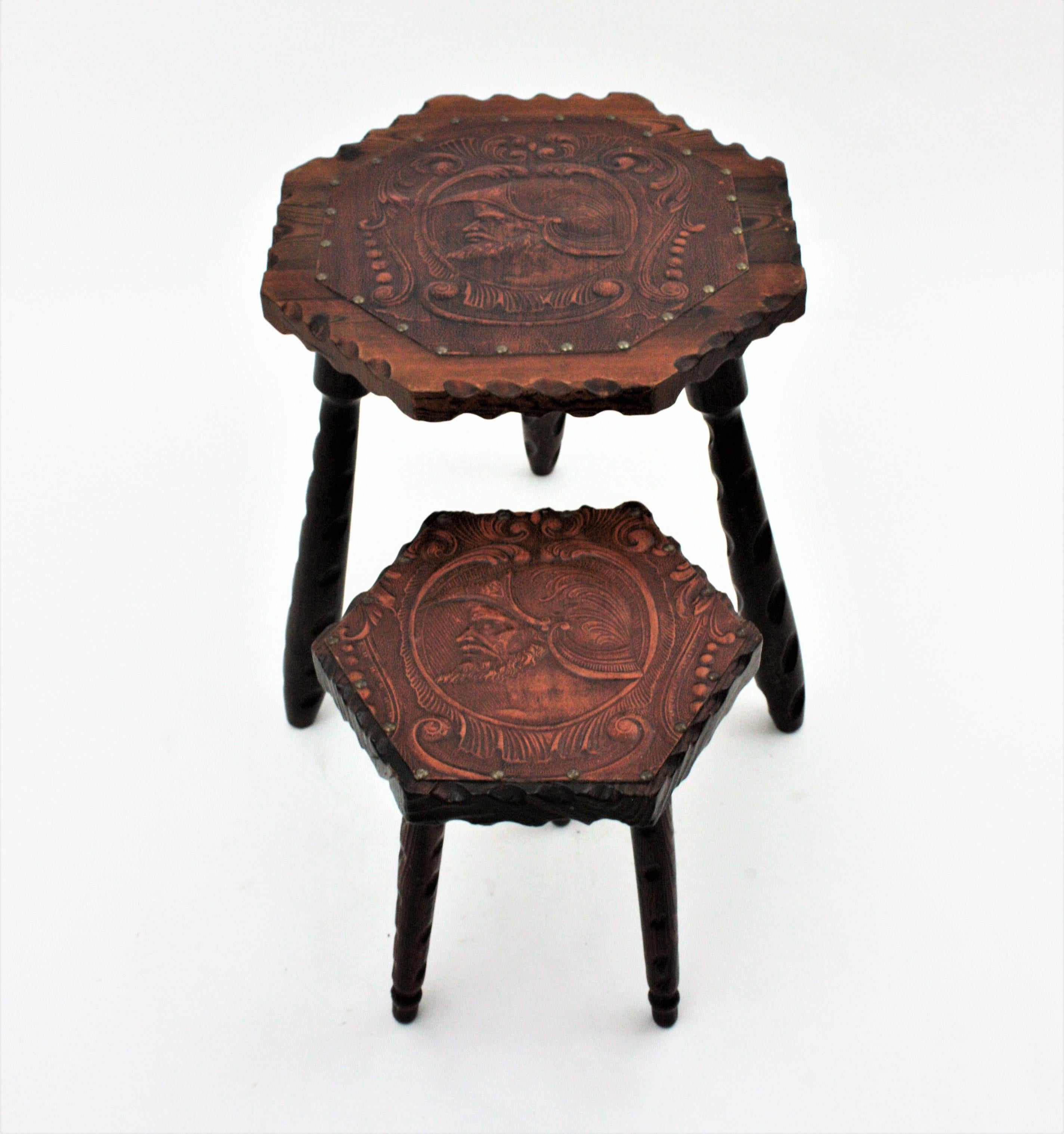 Handcarved pine wood gueridon tables with Leather top and tripod base. Spain, 1940s.
The tabletop in hexagonal shape have scalloped details.Supported on turned legs with scalloped details. Both tops are adorned by a repousse leather ornamentation