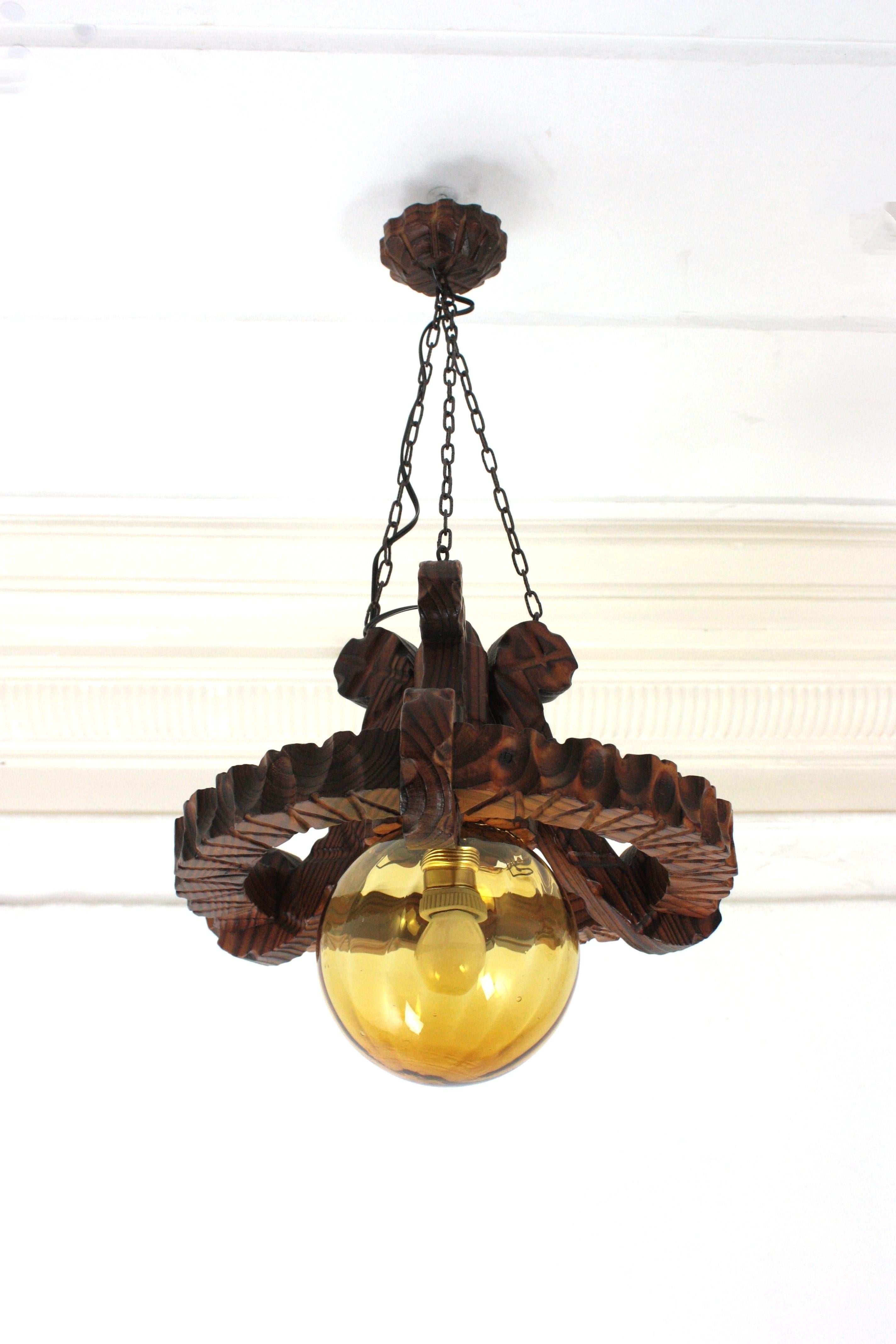 Pair of Spanish Colonial Pendants / Light Fixtures in Carved Wood & Amber Glass For Sale 6