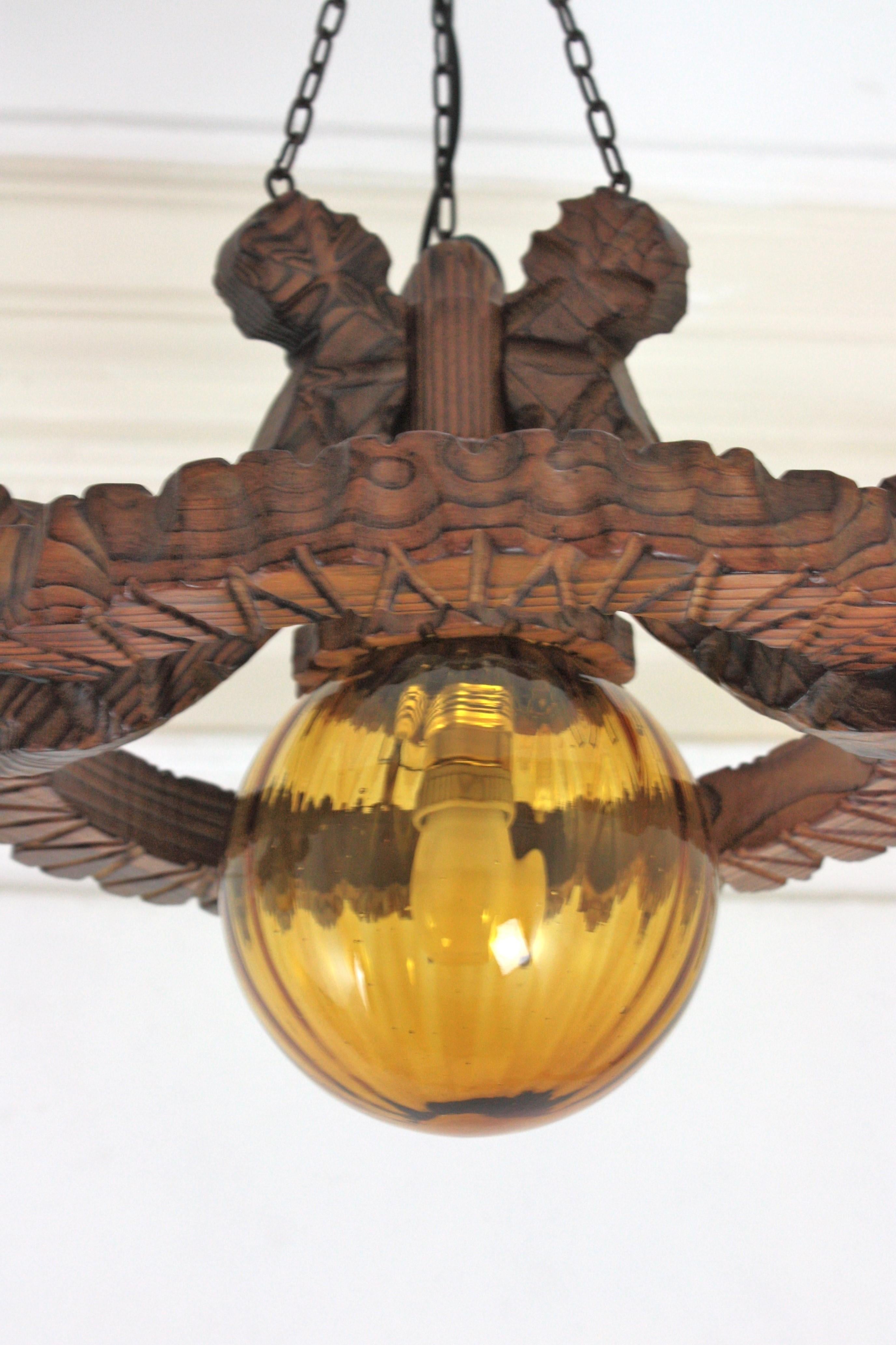Pair of Spanish Colonial Pendants / Light Fixtures in Carved Wood & Amber Glass For Sale 11