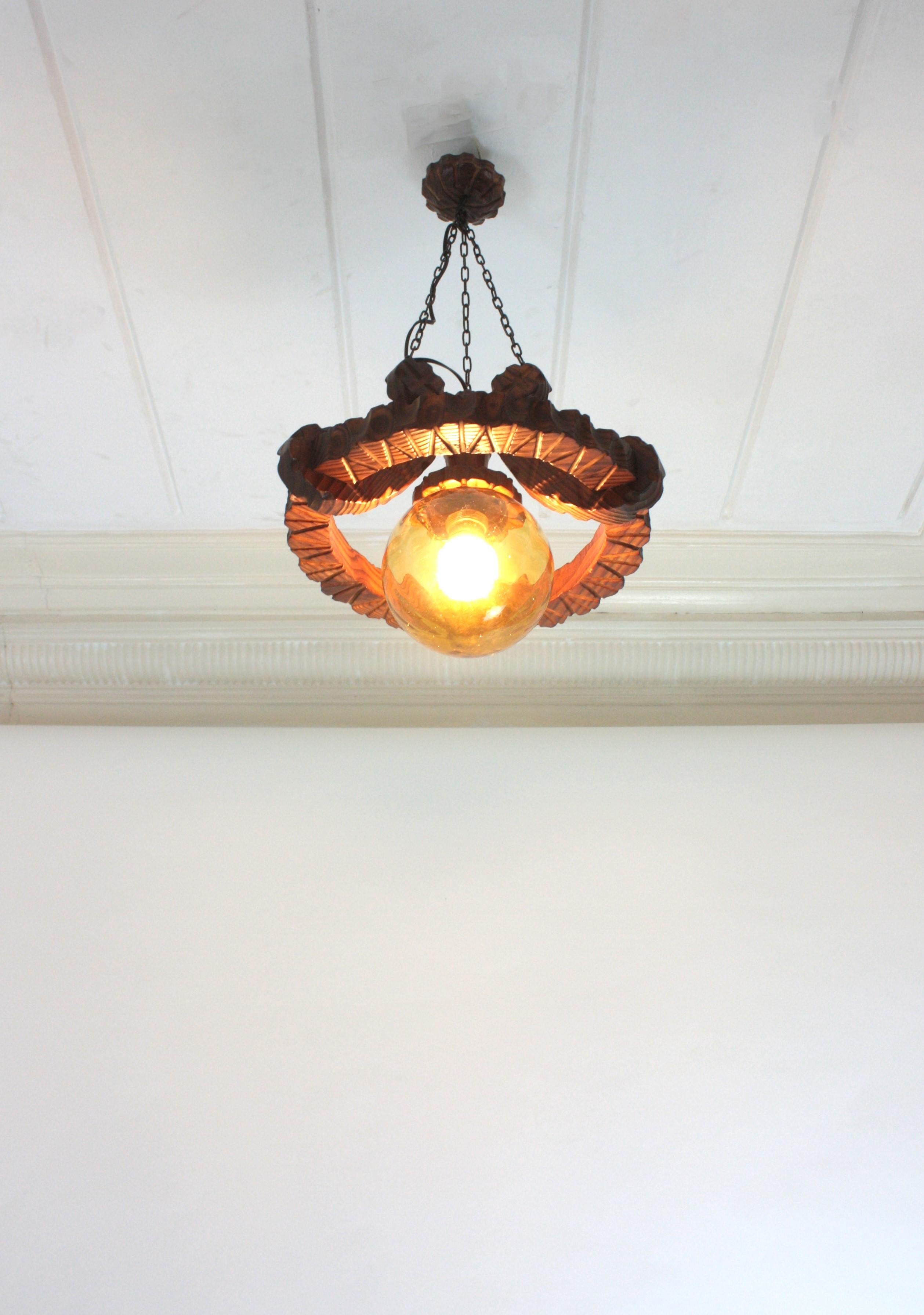 Pair of Spanish Colonial Pendants / Light Fixtures in Carved Wood & Amber Glass For Sale 13
