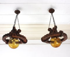 Pair of Spanish Colonial Pendants / Light Fixtures in Carved Wood & Amber Glass