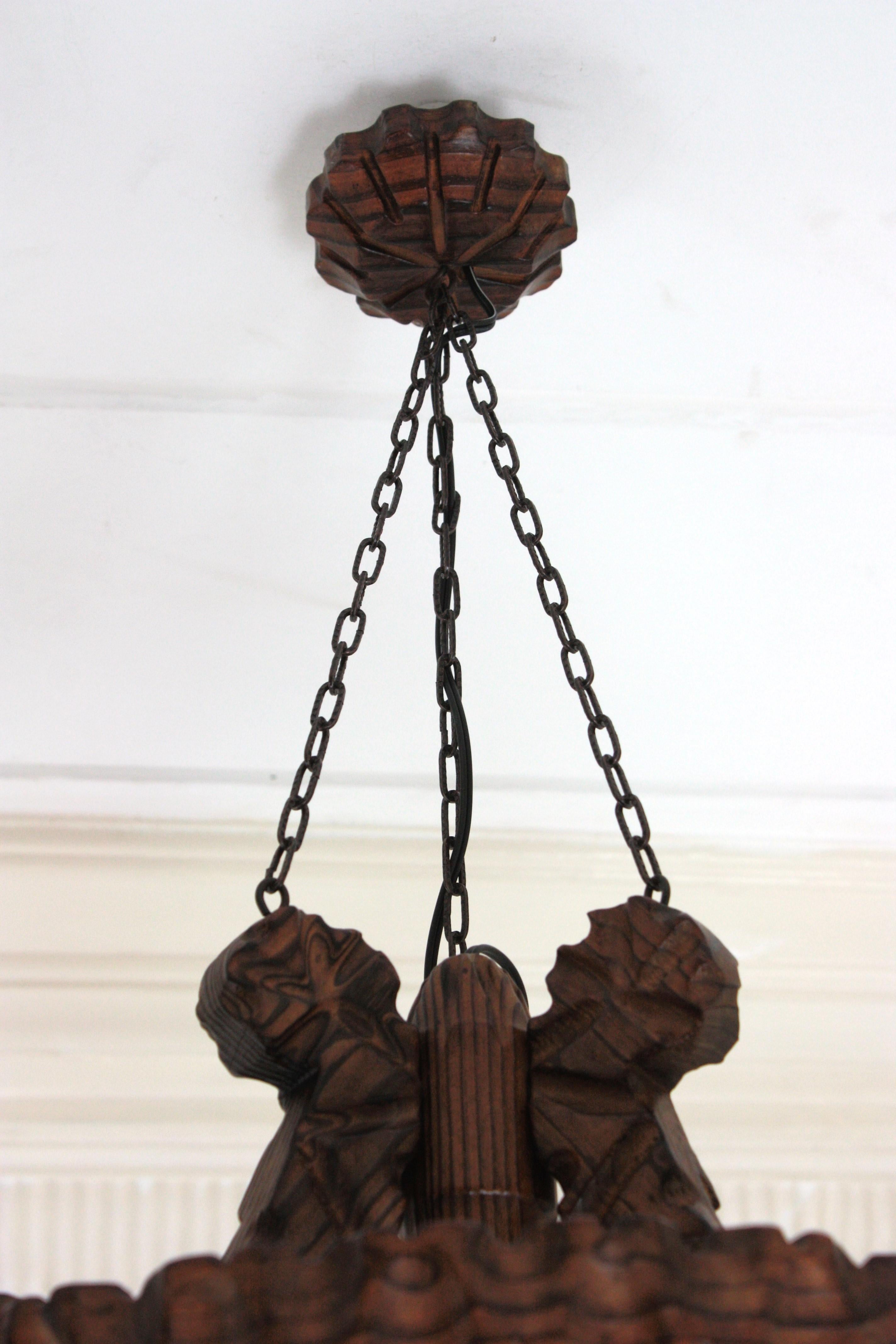 Pair of Spanish Colonial Pendants / Light Fixtures in Carved Wood & Amber Glass For Sale 16