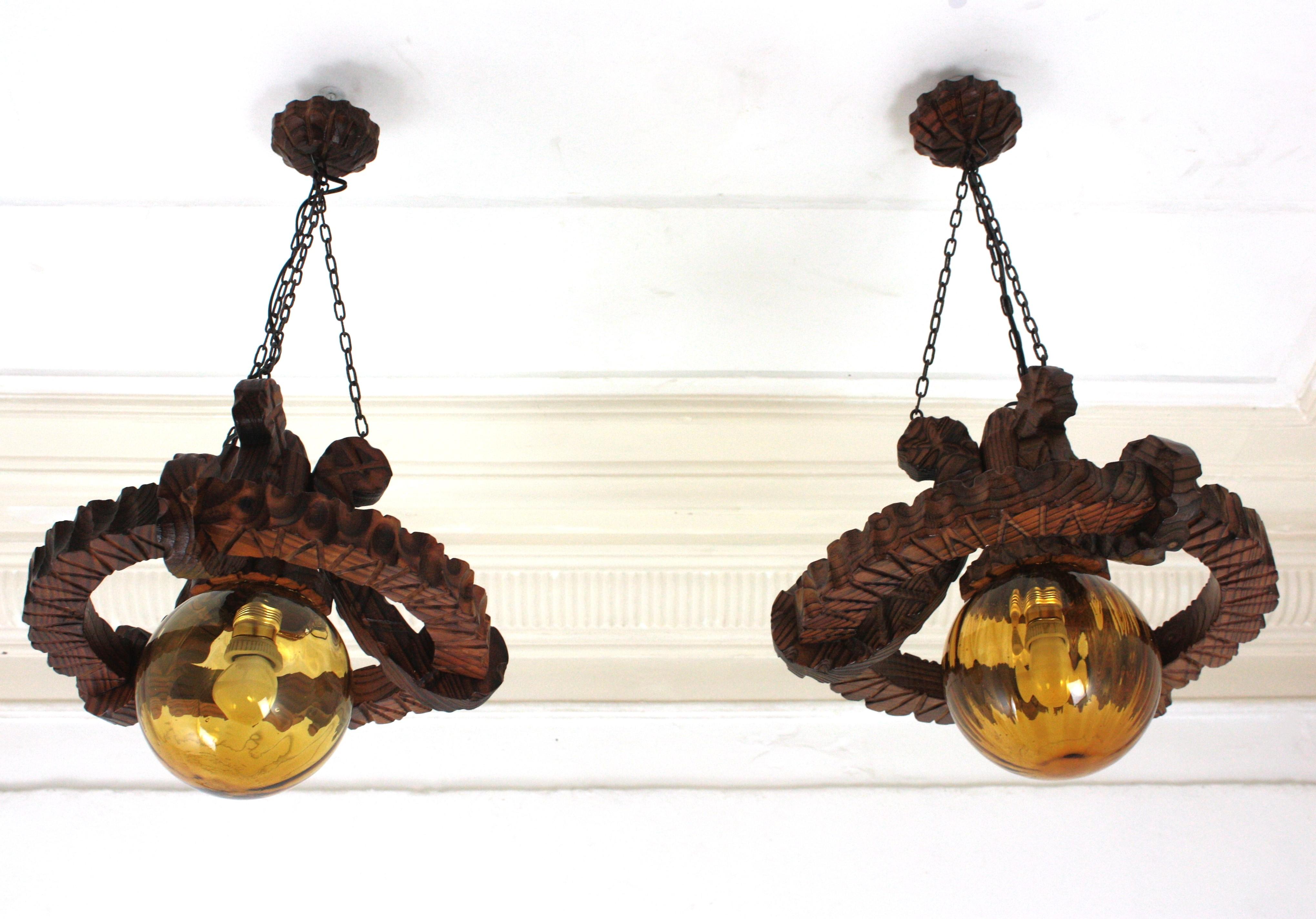 Pair of Spanish Colonial Pendants / Light Fixtures in Carved Wood & Amber Glass For Sale 1