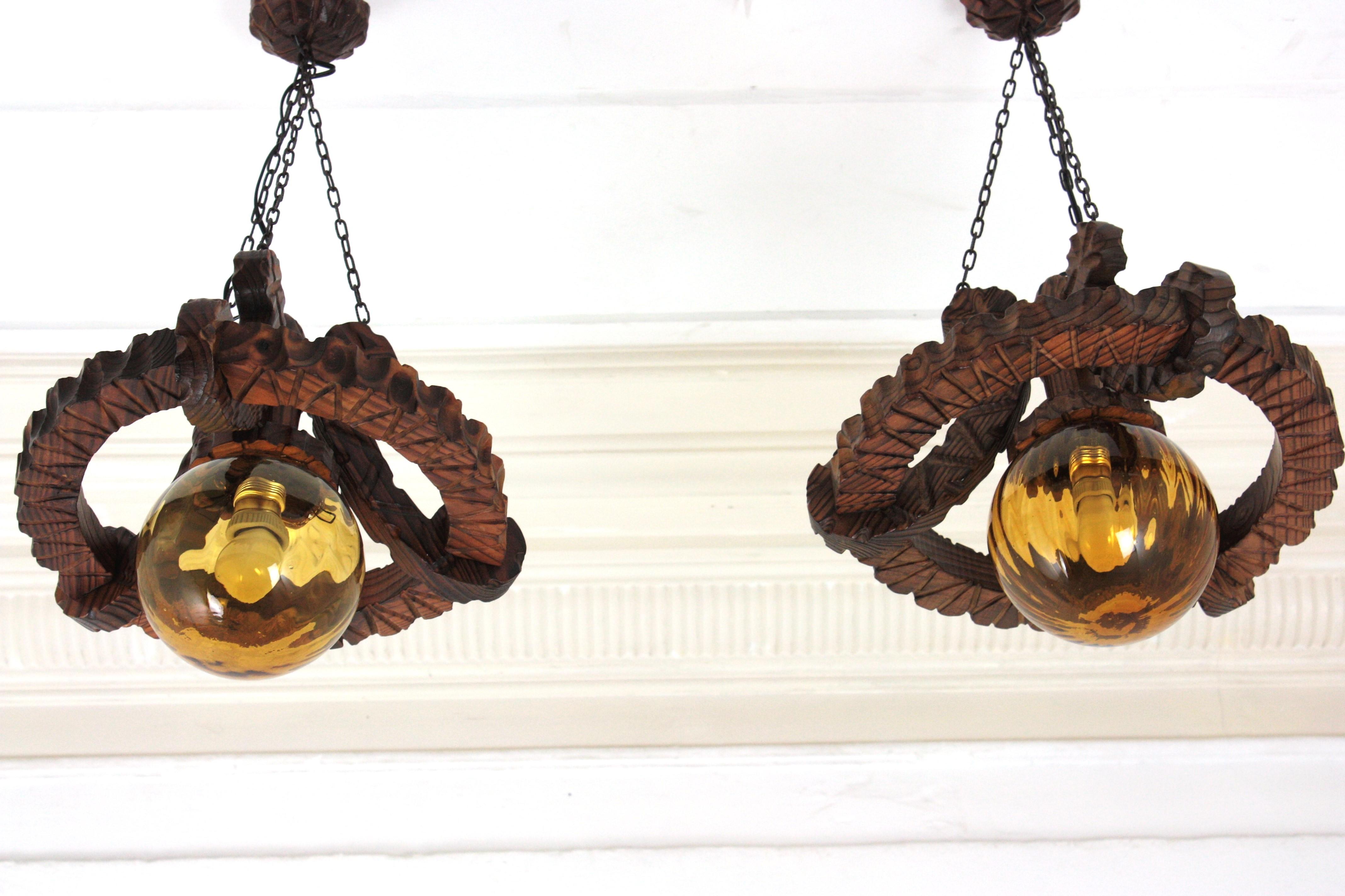 Pair of Spanish Colonial Pendants / Light Fixtures in Carved Wood & Amber Glass For Sale 5
