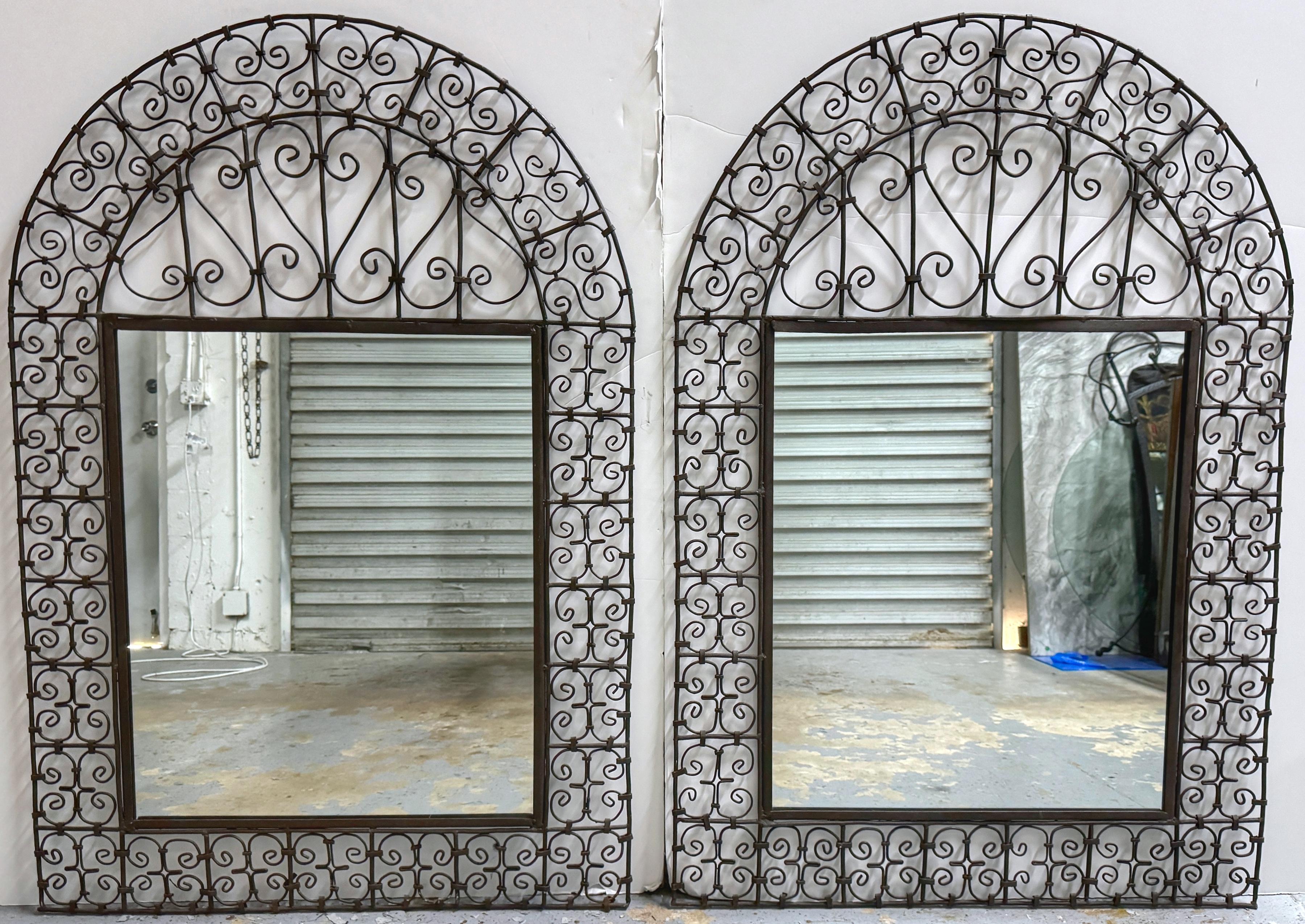 Pair of Spanish Colonial Wrought Iron Trellis Motif Mirrors
Spain, Circa 1960s

A large Pair of Spanish Colonial wrought iron trellis motif mirrors originating from 1960s Spain. Each mirror boasts a neoclassical Spanish Colonial design standing 52