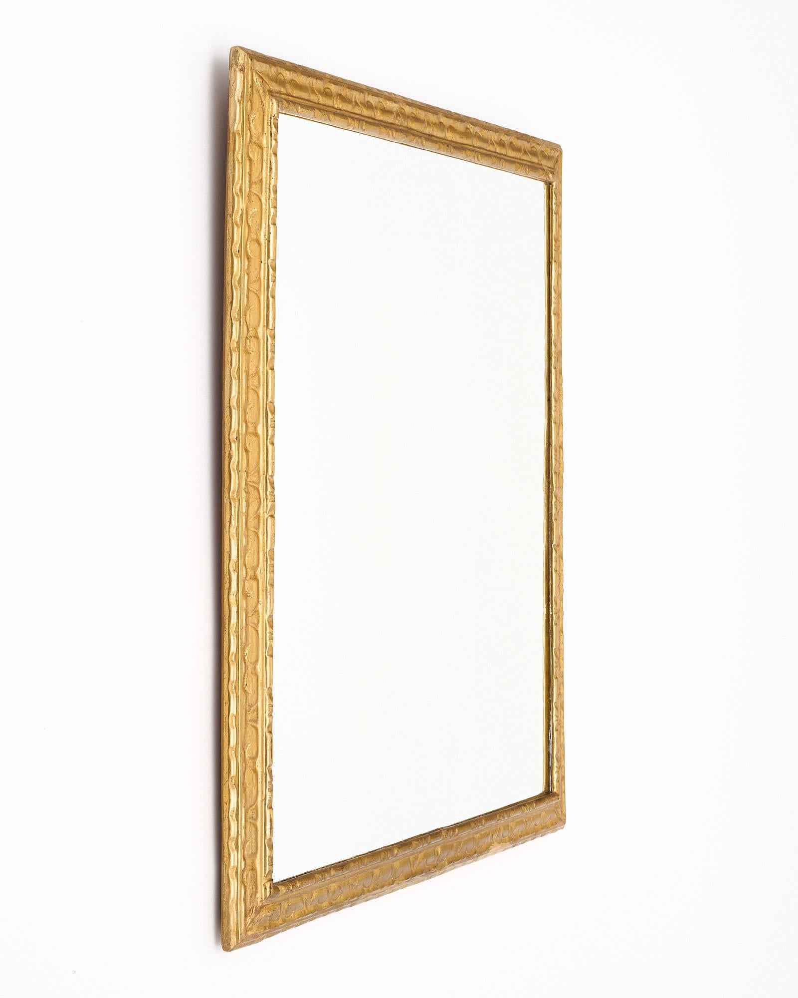Pair of antique mirrors from Spain. 23 carats gold leafed frames. Each features a finely hand-carved pattern to the wood.
