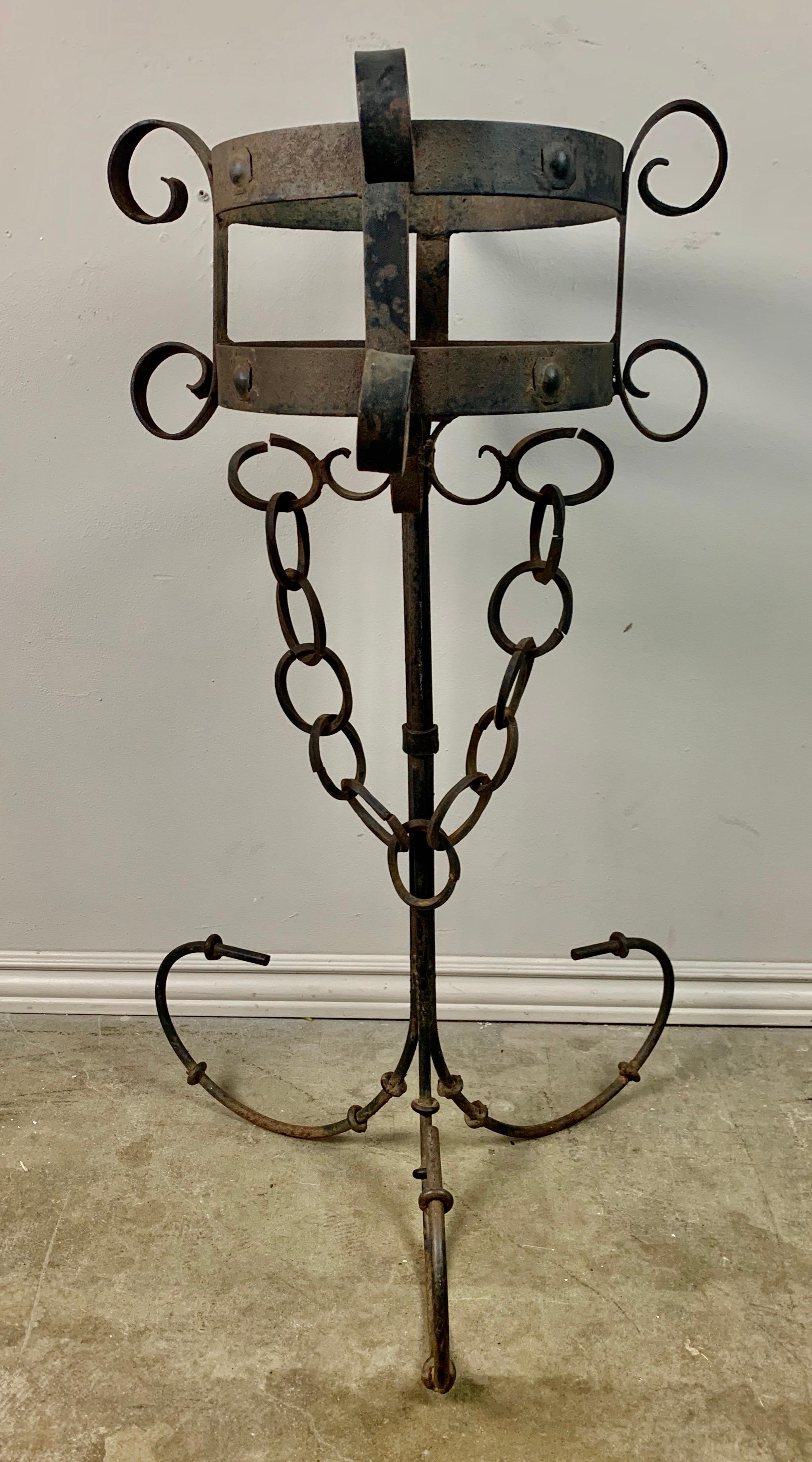 Pair of Spanish hand wrought iron planters standing on tripod bases and decorated with garlands of chain.