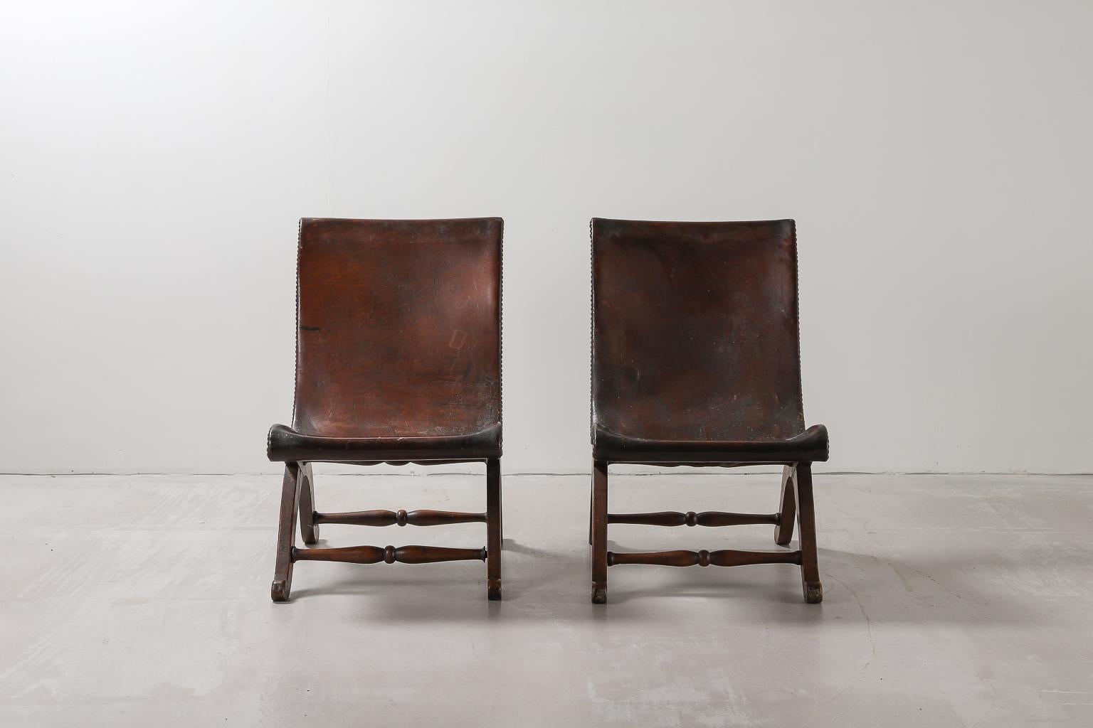 Pair of Spanish leather armchairs by Pierre Lottier for Valenti, 1940s with brass nail head details and original leather. 

Pierre Lottier was born in France before moving to Spain where he worked as a designer, working with the likes of Ava