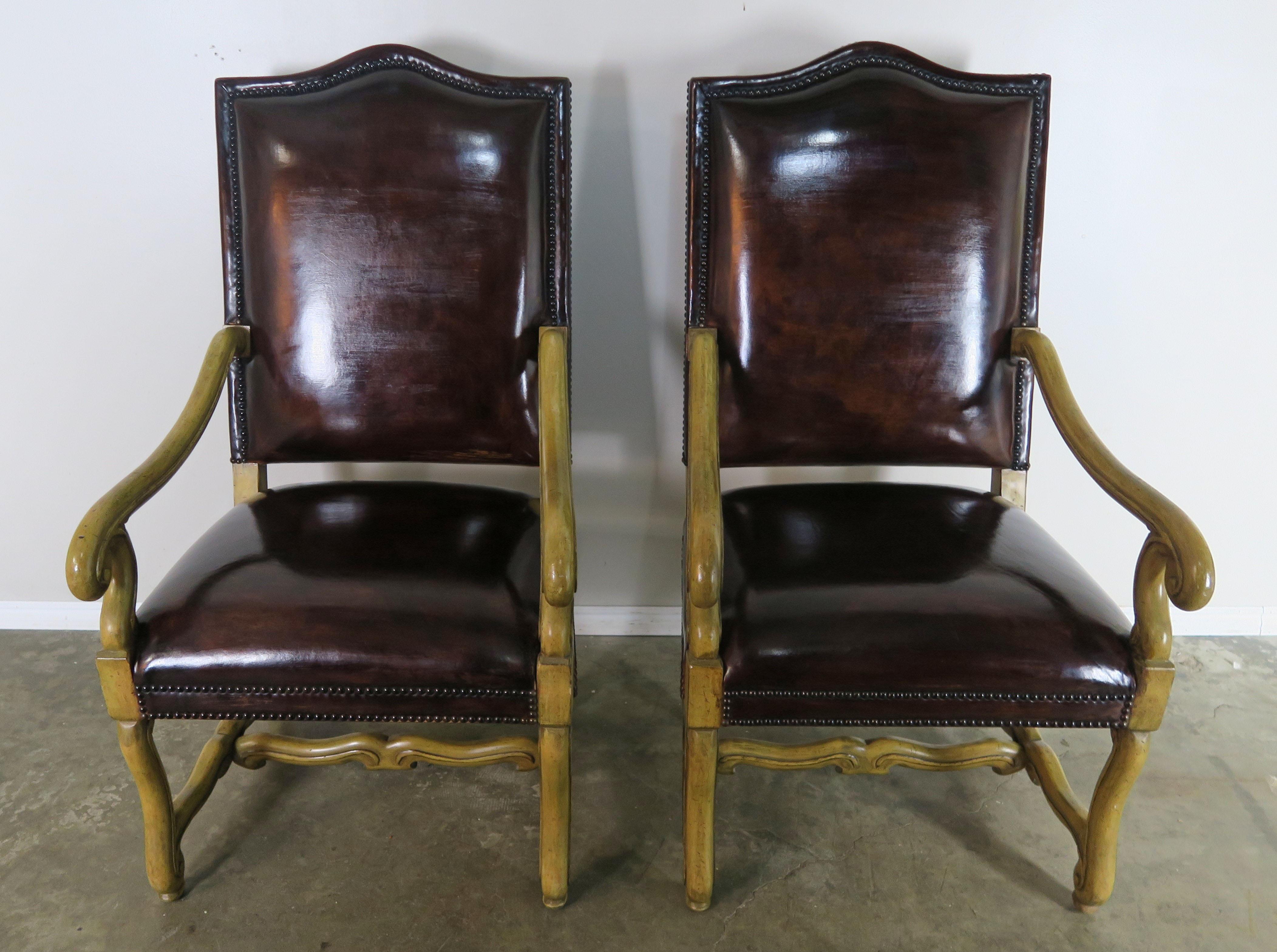 Pair of Spanish style bleached walnut armchairs with dark brown leather upholstery.
Seat height 20
