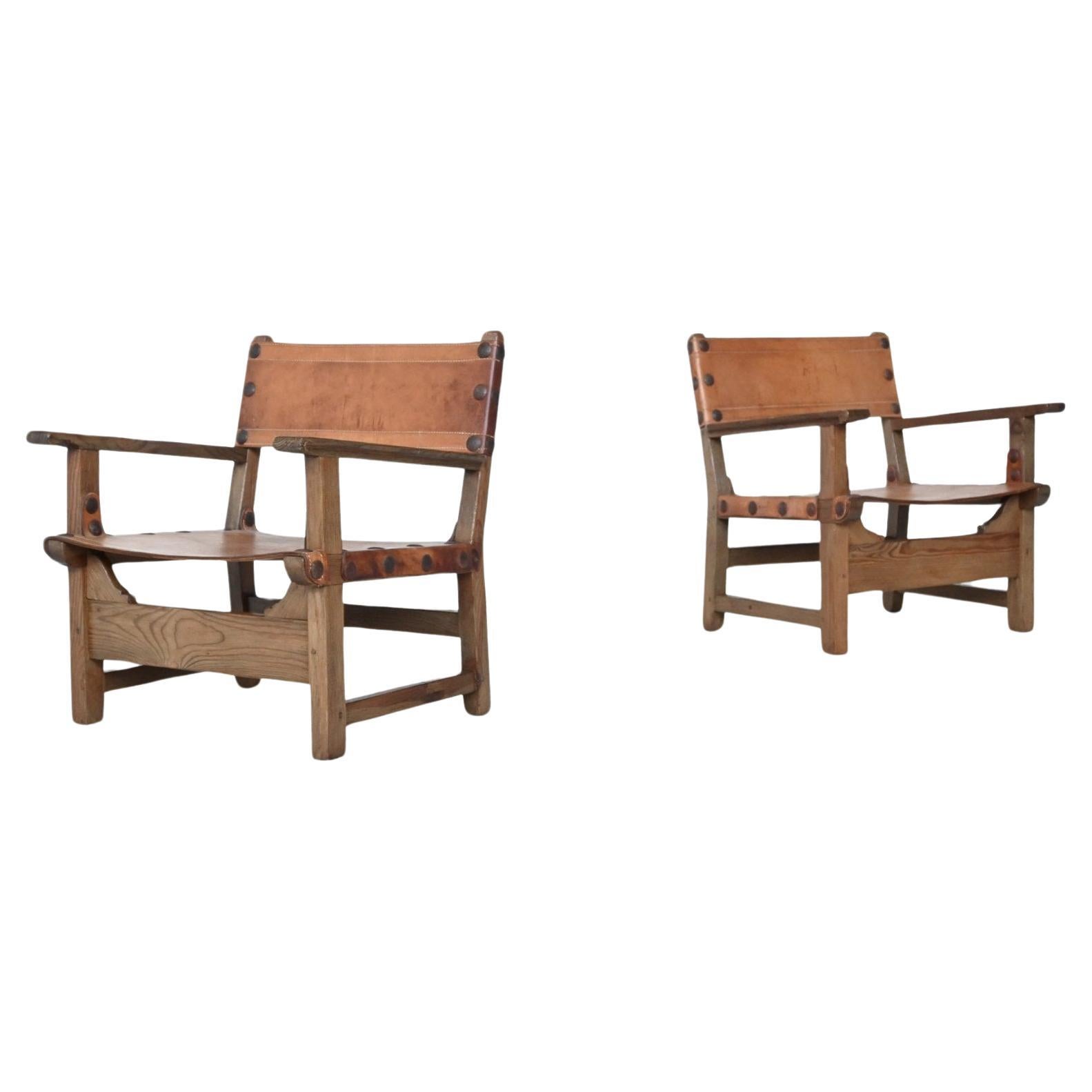 Pair of Spanish lounge chairs oak and saddle leather Spain 1960 For Sale