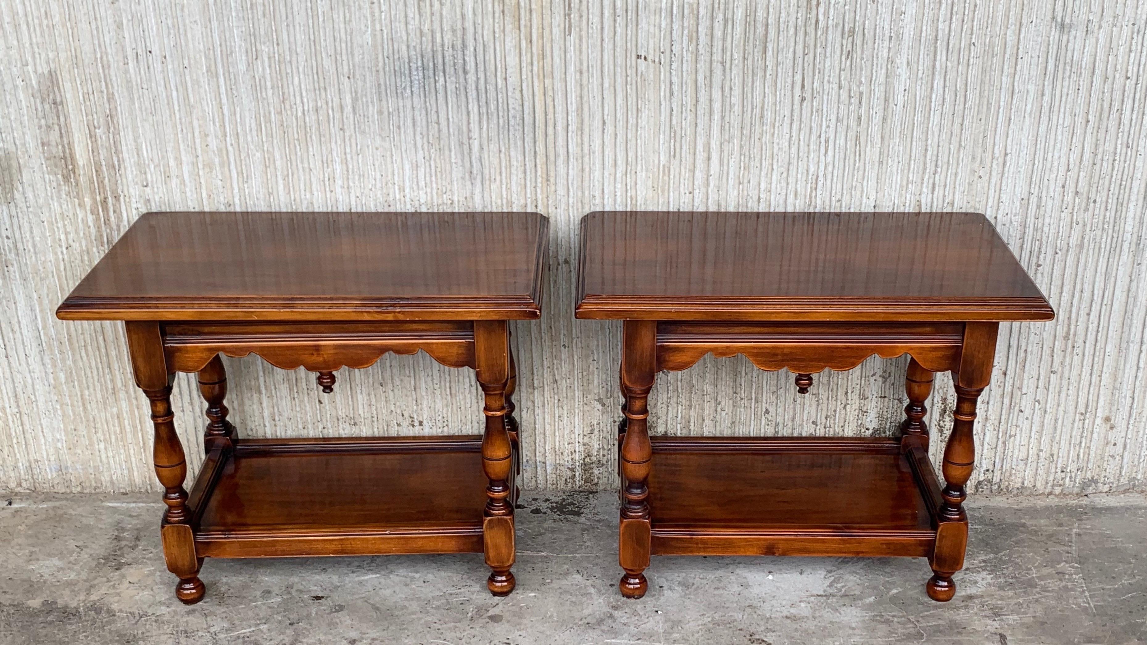 Pair of Spanish nightstands or side, coffee tables in walnut with two shelves.
The legs are turned and the top has a carved inferior detail.