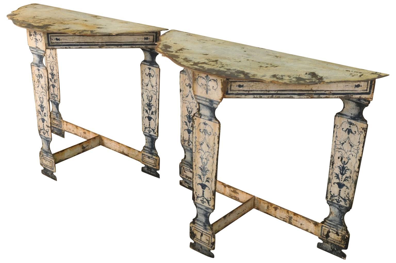 A terrific pair of demilune consoles constructed from painted metal in an 18th century fashion.