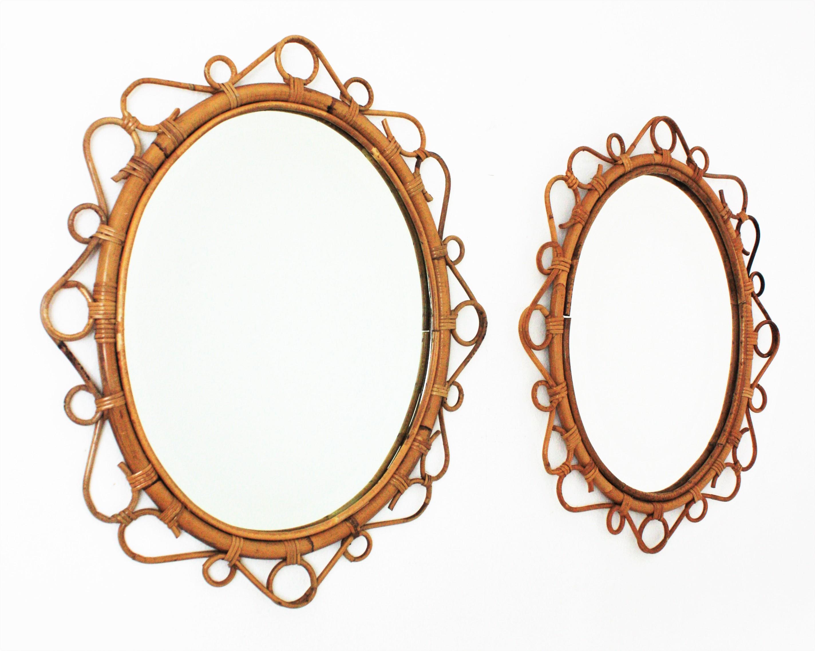 A pair of eye-catching handcrafted bamboo and rattan oval mirrors with scroll detailing surrounding the frame. Spain, circa 1960s.
These Mediterranean wall mirrors feature an oval bamboo frame surrounded by rattan scroll and circle