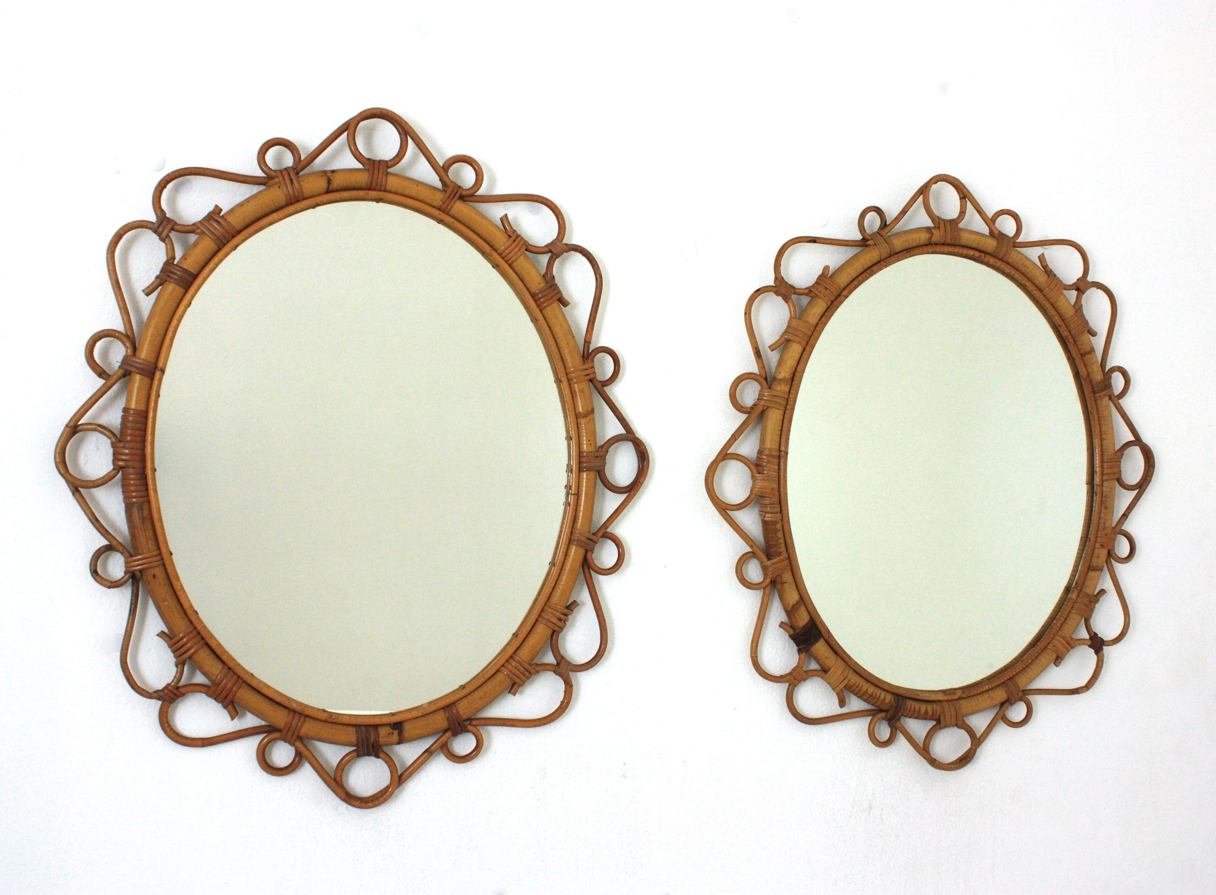 A pair of eye-catching handcrafted bamboo and rattan oval mirrors with scroll detailing surrounding the frame. Spain, circa 1960s.
These Mediterranean wall mirrors feature an oval bamboo frame surrounded by rattan scroll and circle decorations.
They