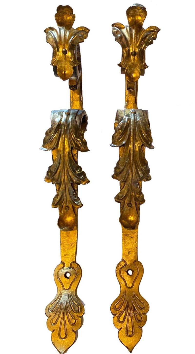 Pair of graceful 1930s Spanish Revival brass-plated iron curtain brackets.