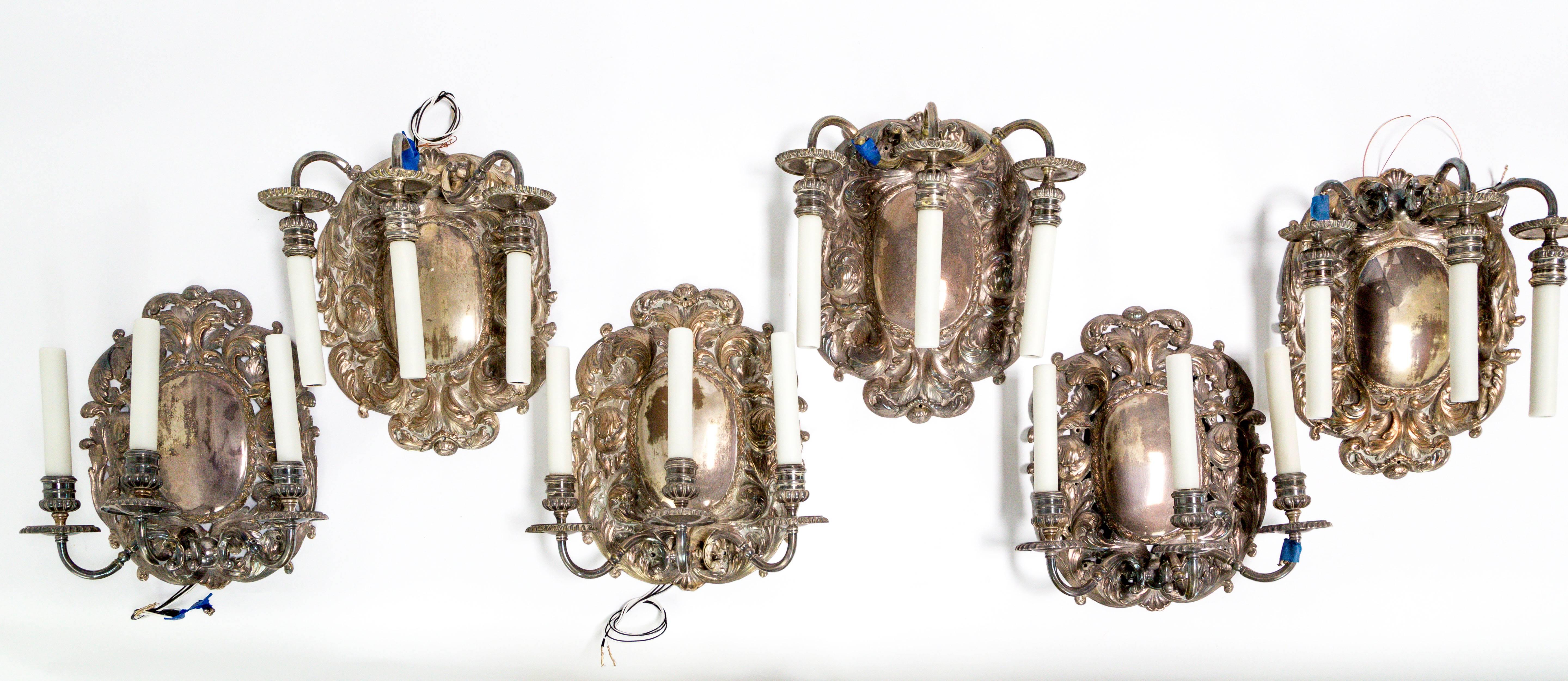 We have six of these gorgeous, shiny, shield sconces with fine acanthus leaf details. Created in Spain, circa 1900-1910, the silver plate over copper is a major highlight of these pieces; each patina has subtle differences in tones and hue,