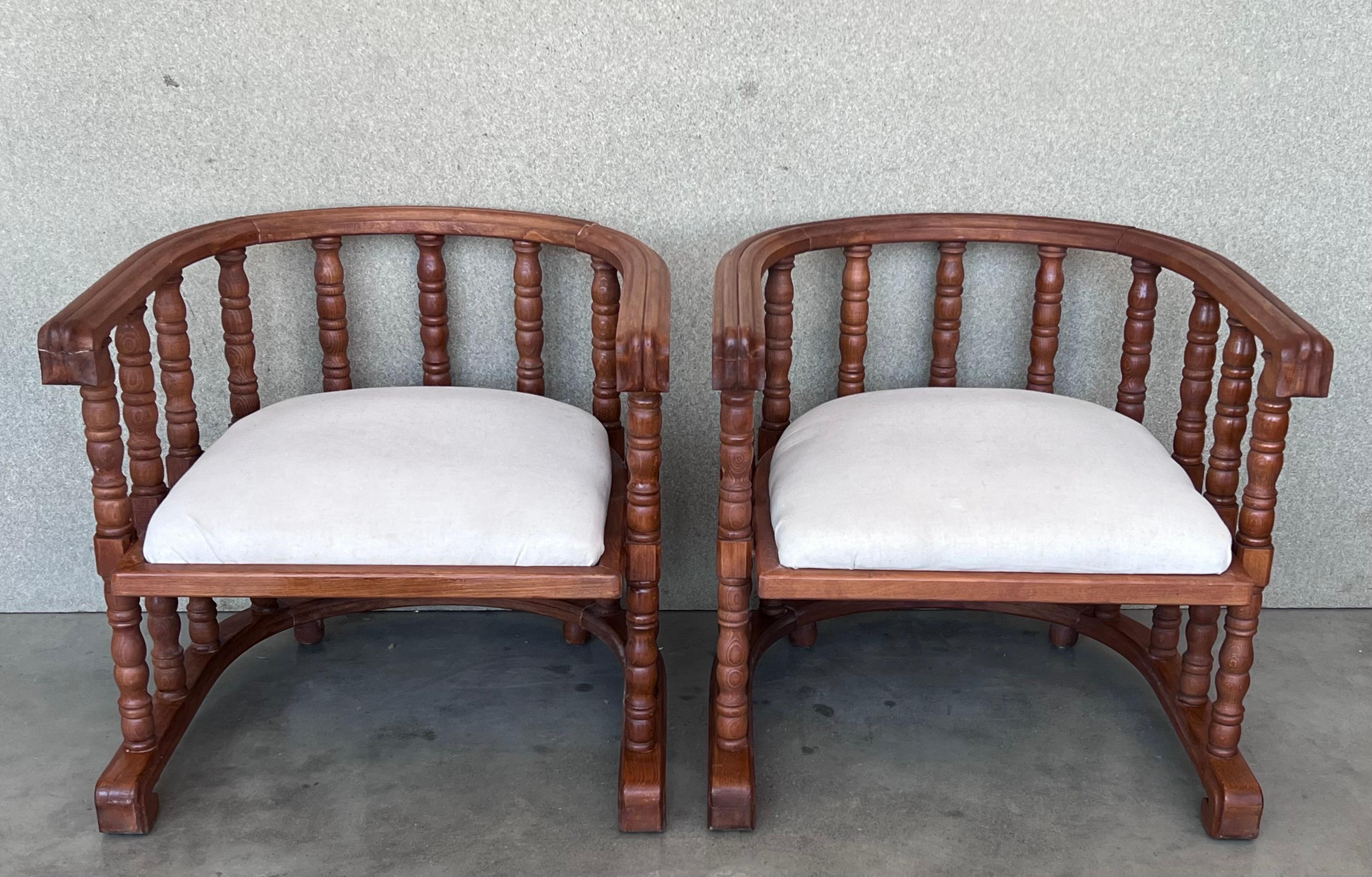 Recently restored pair of vintage walnut framed barrel back chairs with white upholstery.