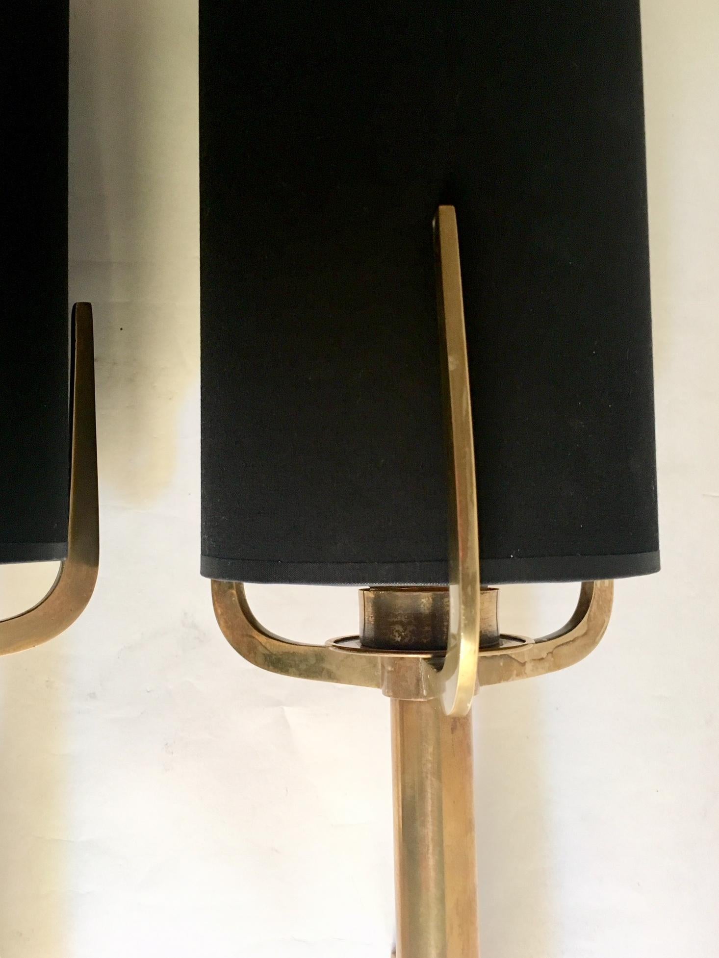 Pair of large Spanish wall sconces, manufactured in brass, ending in three peaks, the shades are new, black with golden interior.