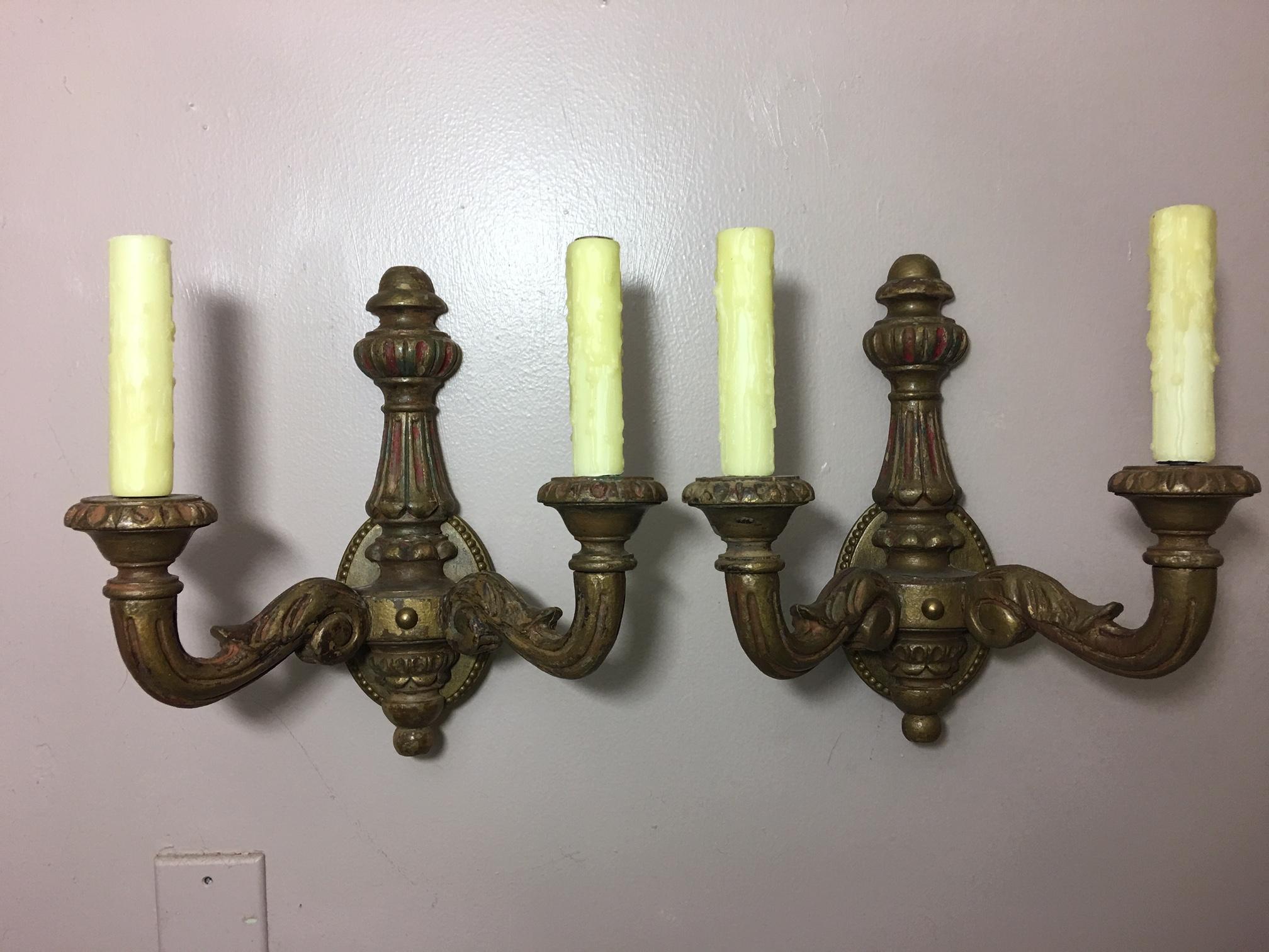 Pair of Spanish two-light carved wood sconces, early 20th century.