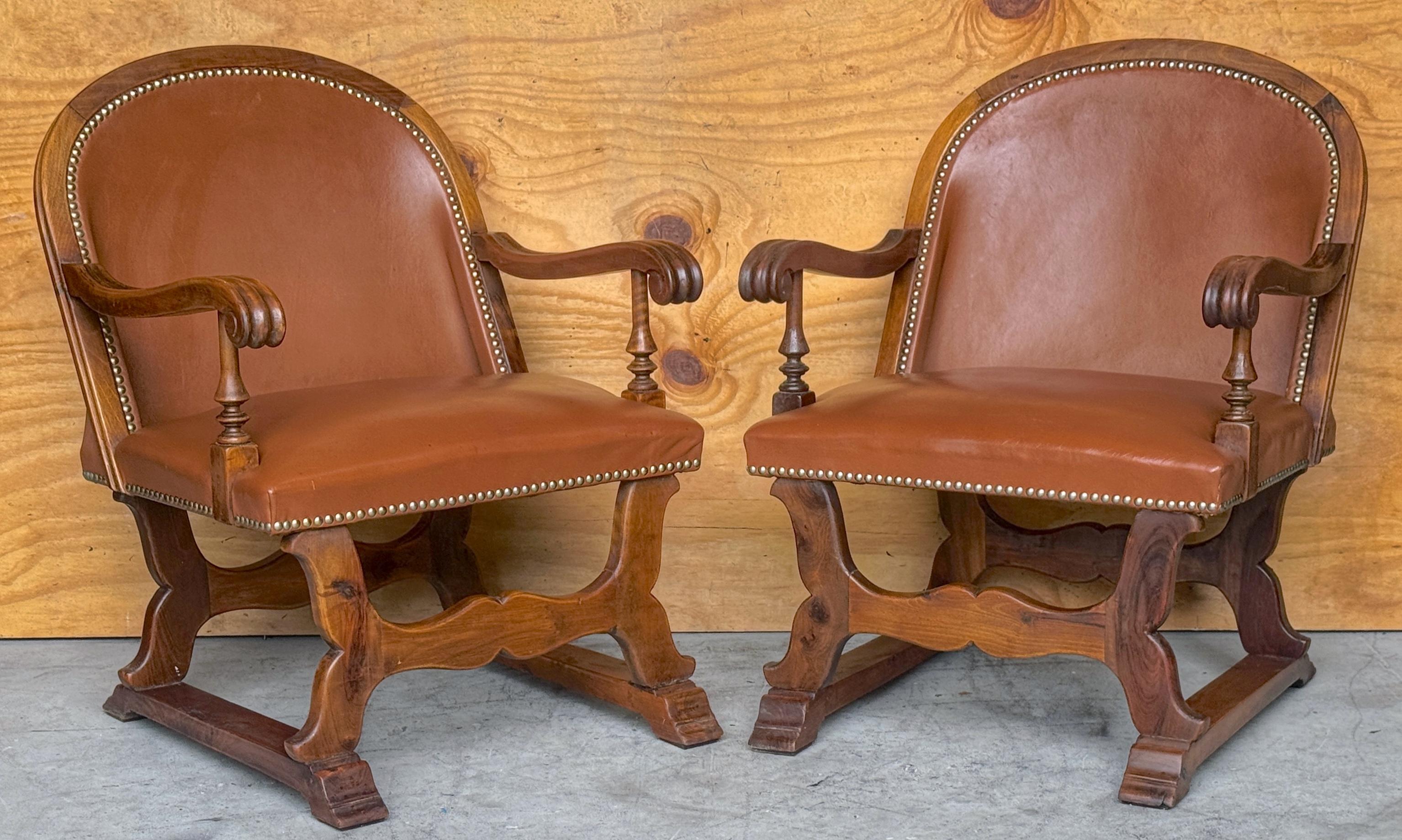 Spagnolo Coppia di poltrone spagnole in noce e pelle con decorazioni a chiodo, CIRCA 1920 in vendita