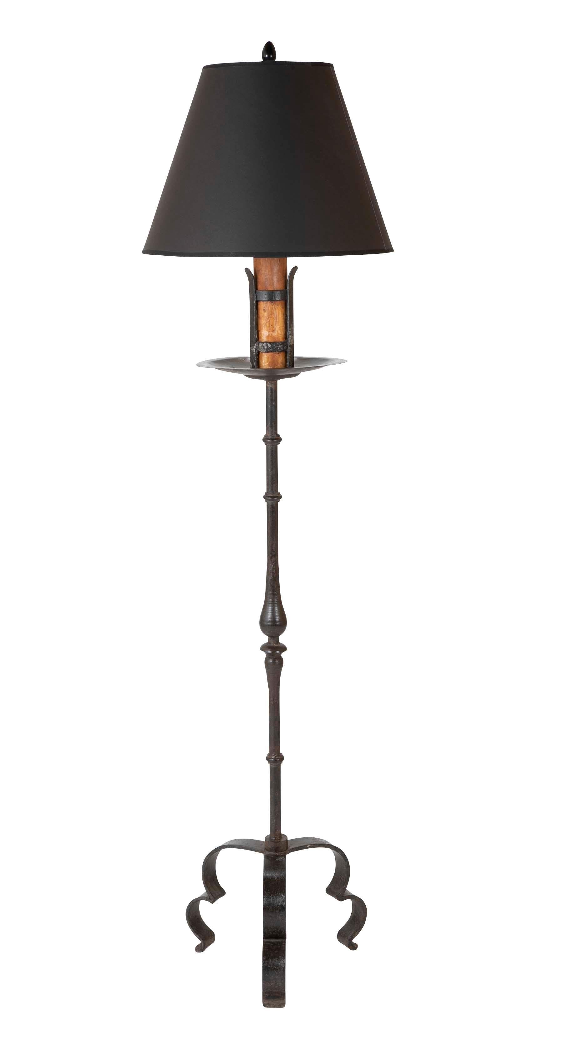 A handsome pair of Spanish Baroque style wrought iron torchère floor lamps with black patina. Beautifully handwrought and turned shaft supported by a tripod bases, the drip pan above holding faux candles.
These date from the late 19th century, a