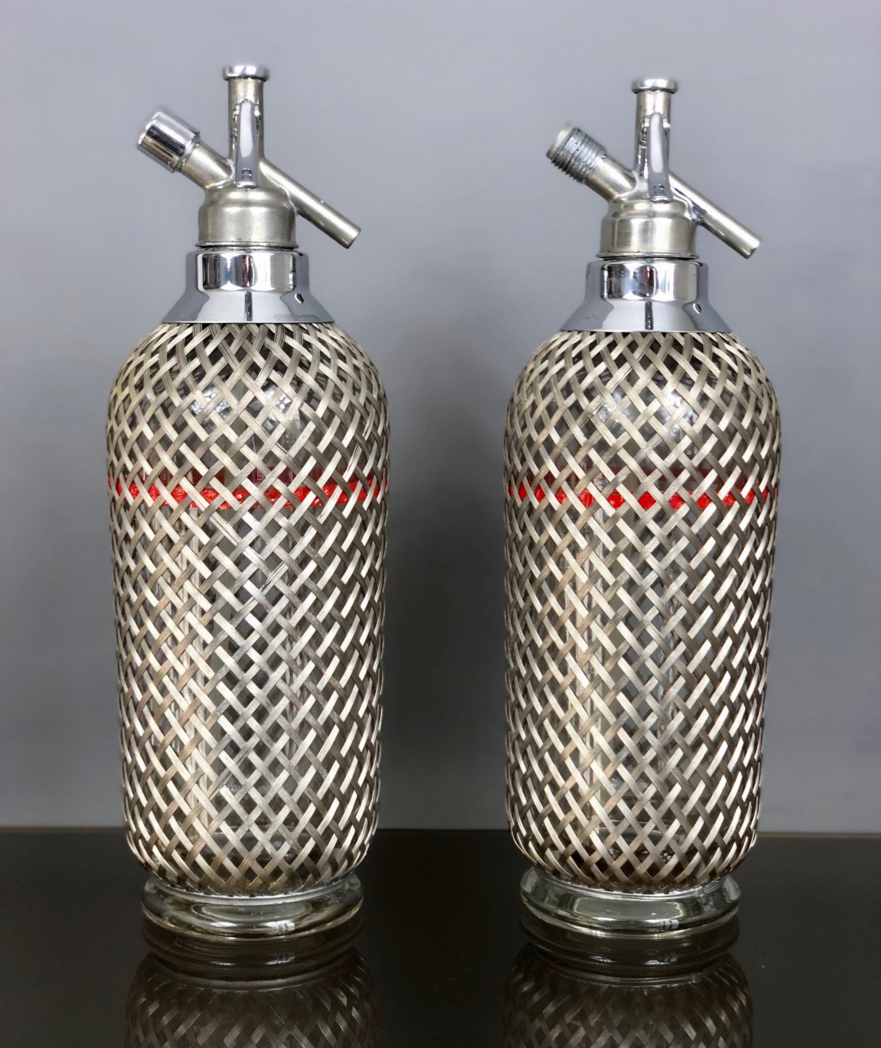 Midcentury English siphons in glass covered by a metal grid. It has the trademark engraved on the bottleneck.
 