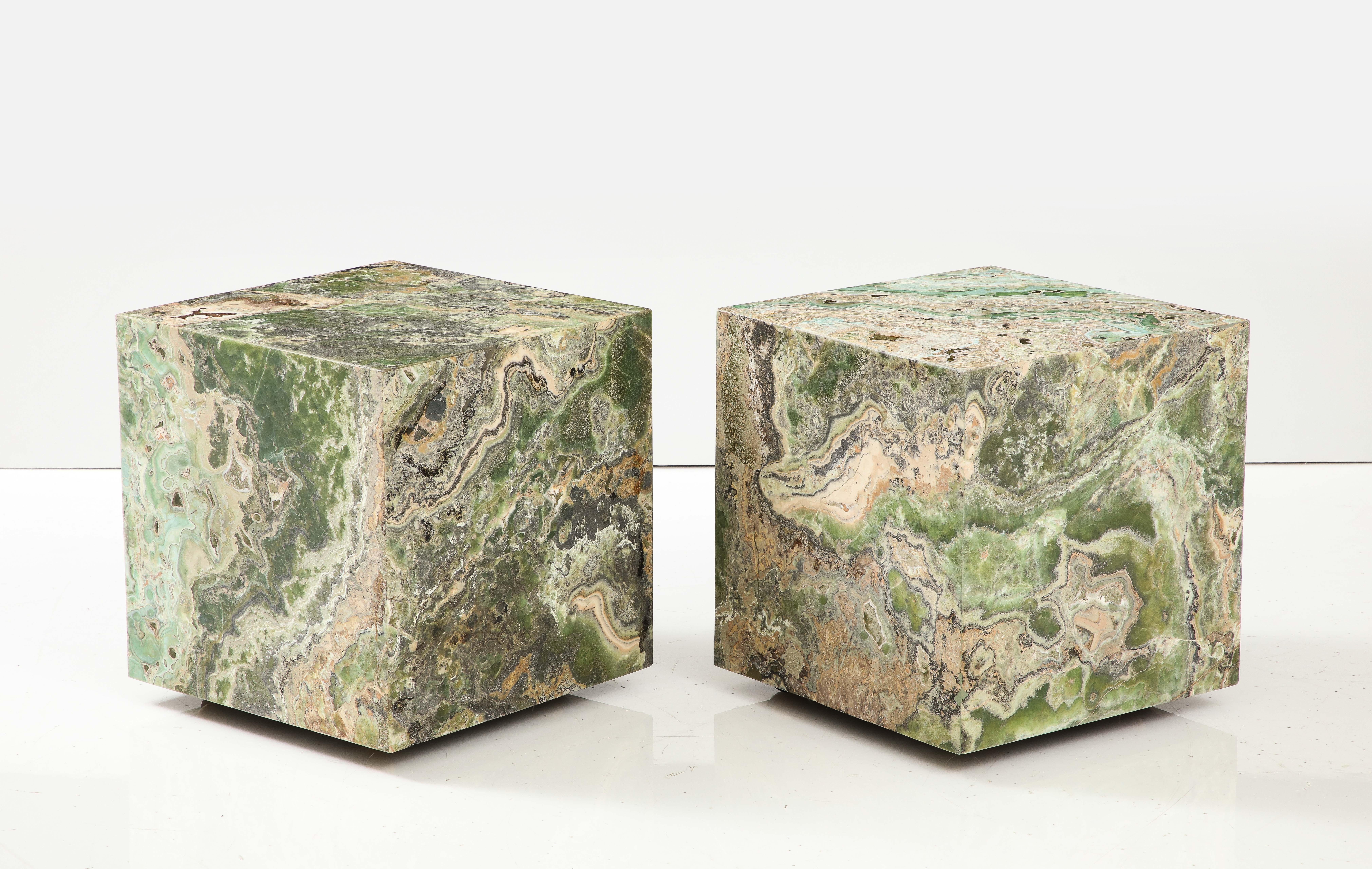 Spectacular pair of custom onyx cubes with a honed finish.
The matte finish of the cubes / side tables give them a wonderful natural look.
They are on brass casters which enables the to be moved easily and placed together if desired to make a