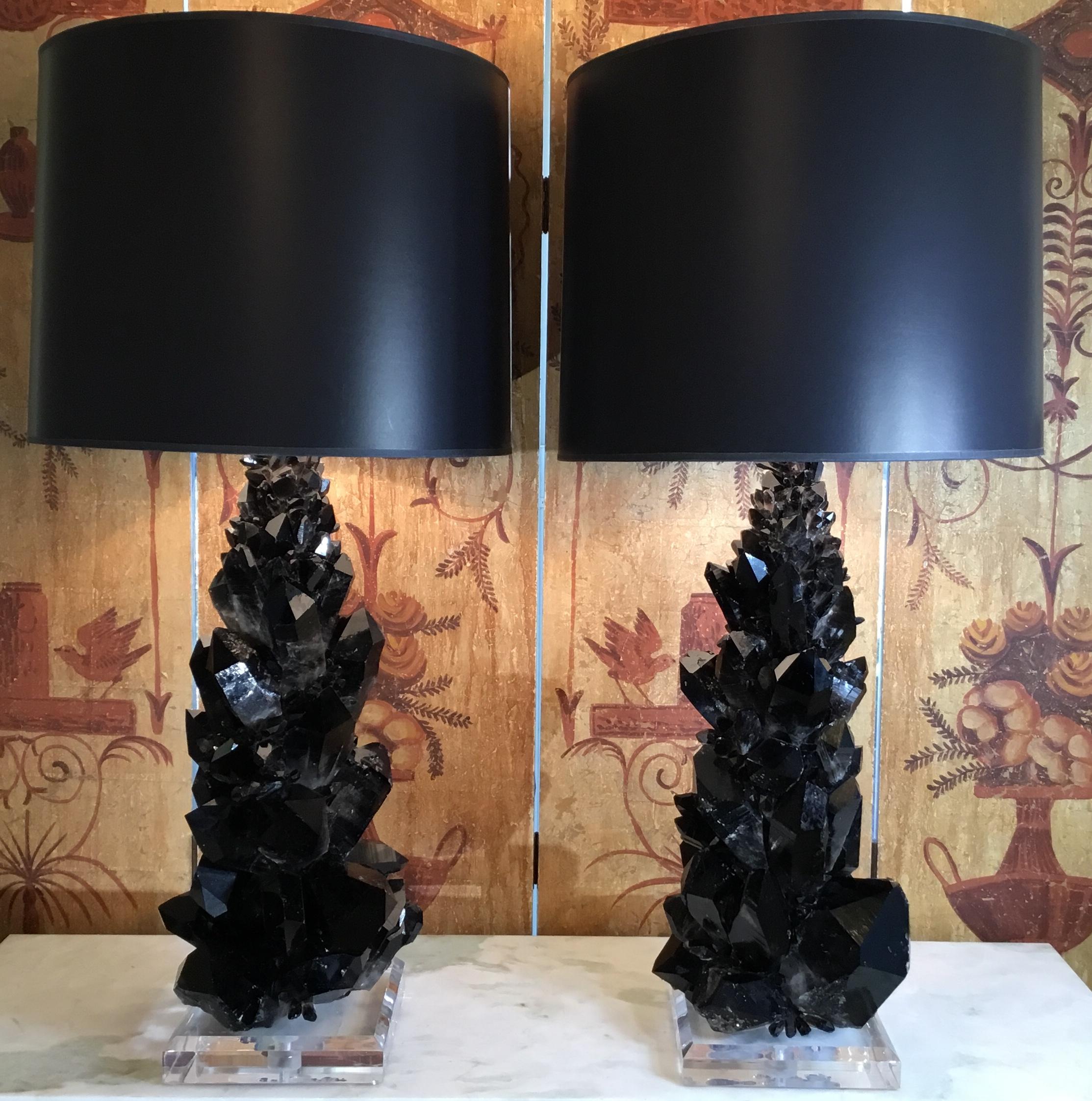 One of a kind pair of table lamp made of large and smaller genuine black and smoky color quartz crystal pieces , artistically put together to make beautiful and impressive pair of lamp.
Bevelled Lucite base, size: 8”x 8” x 1’.5
Height of the lamps
