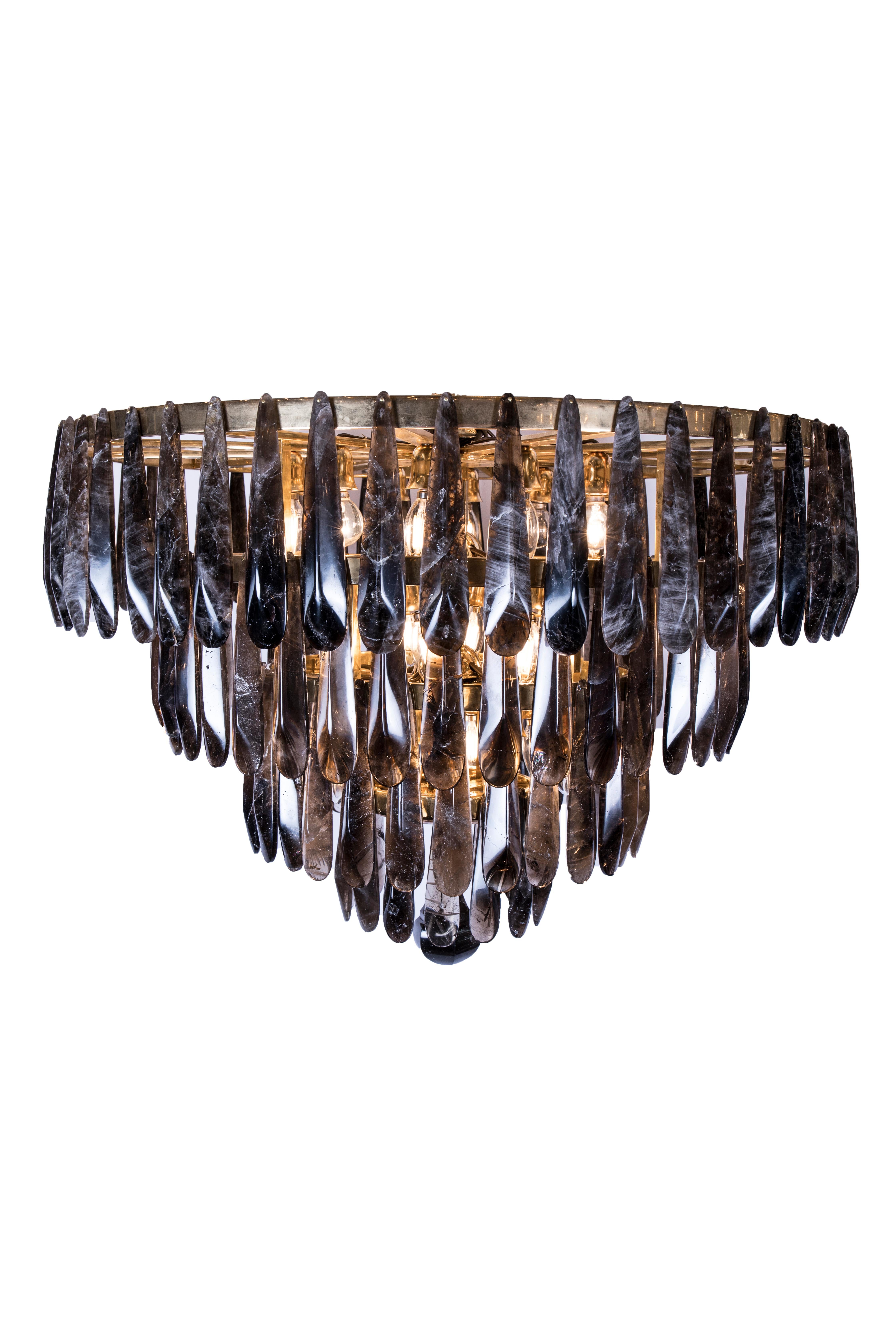 A spectacular and unusual pair of smoked rock crystal chandeliers comprising 4 bronze circular reducing tiers each profusely hung with a total of 135 individually hand carved smoked rock crystal drops. A beautiful solid smoked rock crystal pear drop
