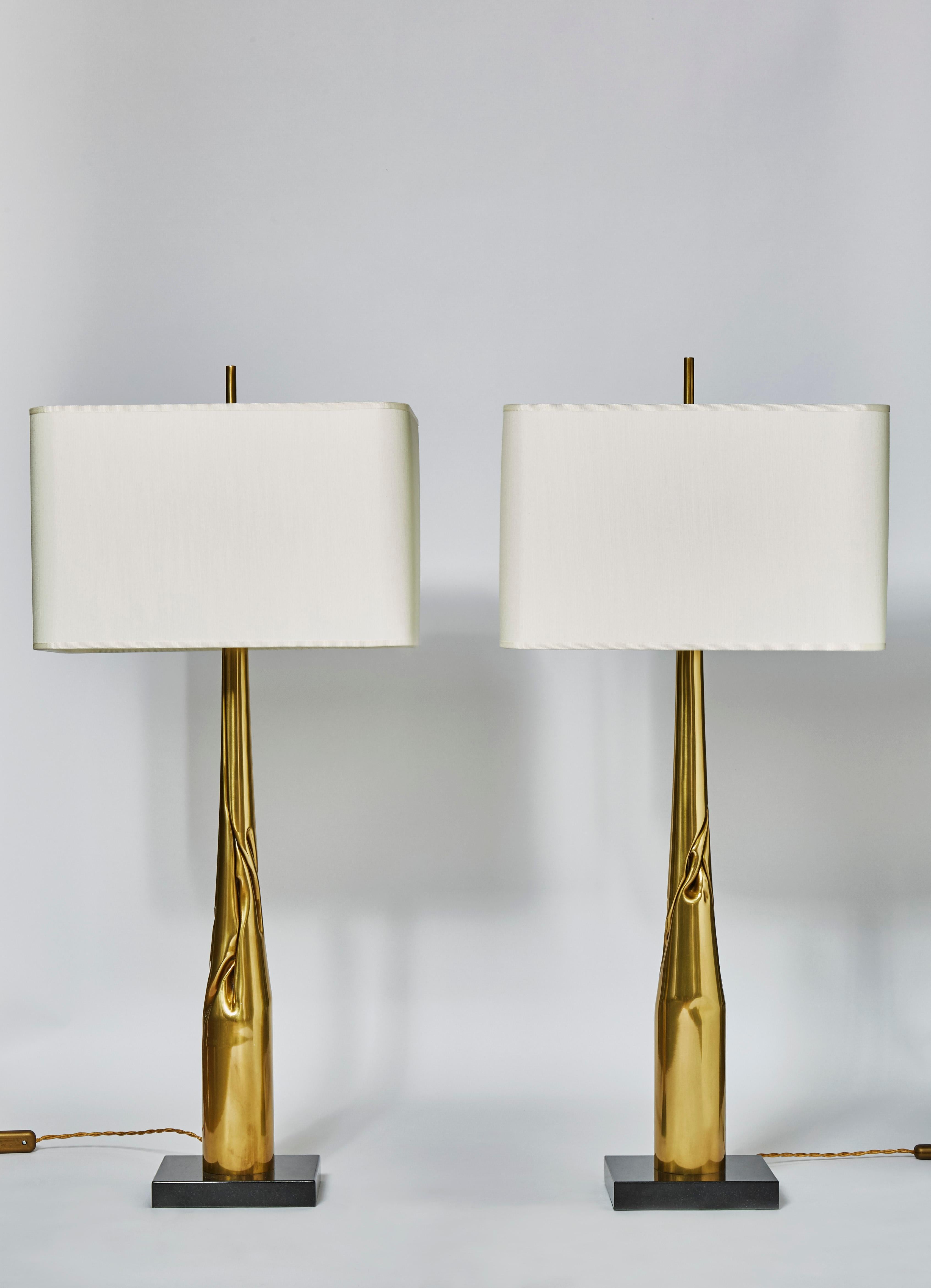 Pair of table lamps made of square black marble bases and twisted and folded brass bodies.

Each lamp is unique, made by the edition house Esperia exclusively for Glustin Luminaires.