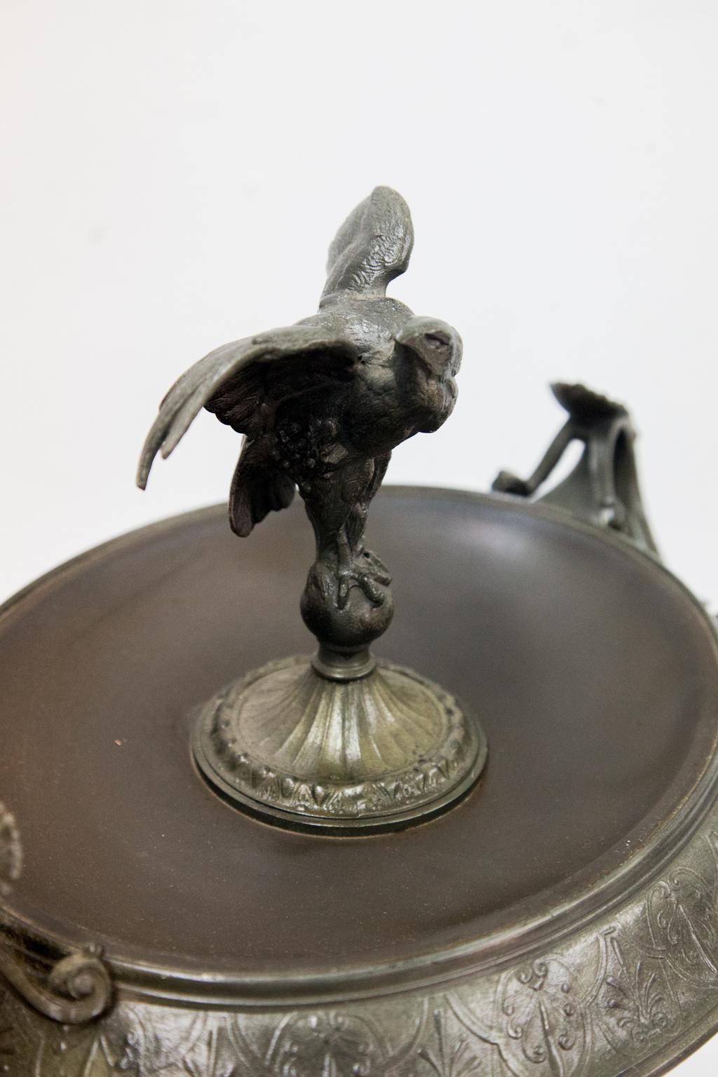 Pair of Spelter and marble comports have center finials of winged eagles, the Rococo base with hairy paw feet. They are each inlaid with a malachite panel.


          